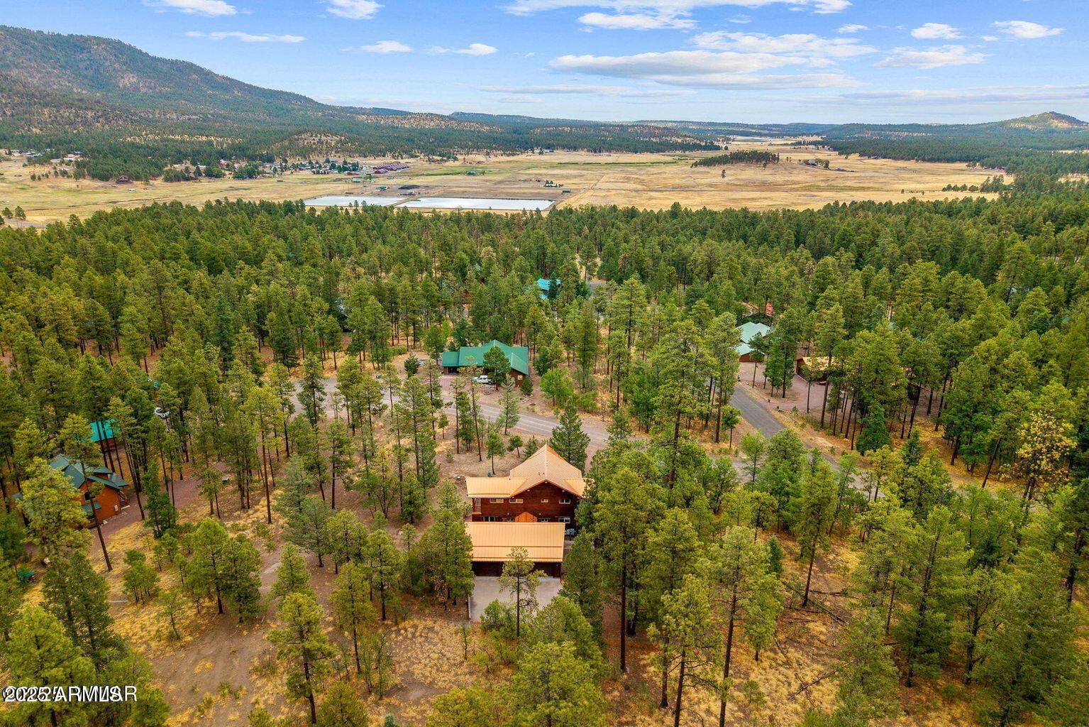 *** Turnkey Multi-Generational Retreat Bordering National Forest - Alpine Forest Estates*** Welcome home to this fully furnished, turnkey custom masterpiece nestled at the base of South Mountain in the highly desirable Alpine Forest Estates, This rare property backs directly to the Apache-Sitegaves National Forest, offering unmatched privacy, seclusion, and endless recreation Spanning 2,353 sq. ft., this home features 4 bedrooms, 3 full bathrooms, and multiple living areasperfect for large families, kids, grandkids, and visiting friends. The thoughtful multi-generational floor plan includes a main-level primary suite with spa-style bath, an additional bedroom and bath on the main, plus two spacious bedrooms upstairs (one large enough to serve as a game room). The upper level also offers a loft, office space, and balconies with French doors to enjoy the crisp mountain air.
Inside, the great room impresses with floor-to-ceiling windows, knotty alder cabinetry, granite countertops, a gas fireplace, and custom tile accents. Outside, relax on the expansive 1.5-trek wraparound covered deck, perfect for morning coffee, Sunday barbecues, or wildlife watching.
Additional highlights include:
Fully finished 3-car detached garage with cabinetry, Rinnai heater, and large workbench, connected by a covered breezeway
Generac automatic-start generator, 1,000-gallon in-ground propane tank, Rinnai tankless water heater, and Amana dual-zone A/C
ADA-friendly upgrades with wide hallways and doors
Game-ready backyard with horseshoe pit, concrete game pad, and gas stub for a barbecue
Mudroom with Kohler sink, washer & dryer included
This home is truly move-in readyjust bring your clothes and food. Ideal for year-round or seasonal living, entertaining, and holiday gatherings.
Alpine is celebrated for its world-class hunting, fishing, hiking, biking trails, lakes, rivers, and streams, and is just 40 minutes to Sunrise Ski Resort for four-season recreation. With pride of ownership and every detail in place, this property is ready to become your family's Alpine retreat.
Welcome to Alpinewelcome home.