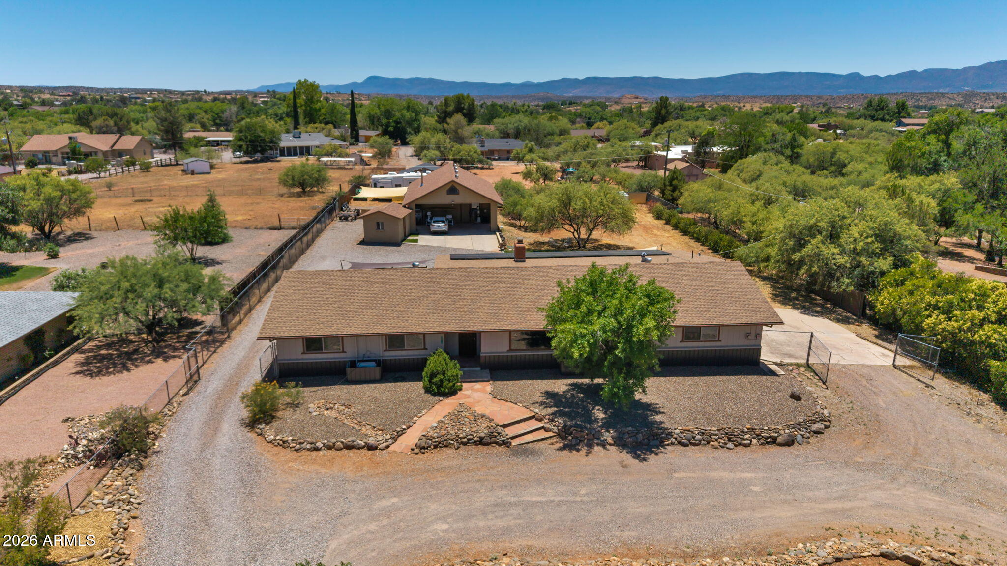 Rare opportunity in desirable Mel Glo Estates! Situated on a private, elevated 1-acre parcel with perimeter fencing, this unique Cornville property features a 2,800 sq. ft. home and an impressive 1200+ sq. ft. detached shop, offering exceptional space for hobbies, projects, storage, or a home-based business. The 4-bedroom, 2.5-bath home has been thoughtfully updated with a new roof (2025), owned solar system, multiple energy-efficient mini-split heating and cooling units, updated engineered oak flooring, and new front-facing windows.

The primary suite opens through custom-crafted double doors to a private patio complete with a hot tub, creating a peaceful retreat. A dedicated home gym is conveniently located just off the dining area, while a covered patio ....SEE MORE off the laundry room provides additional space for entertaining and enjoying the property's tranquil setting.

The versatile workshop includes a 3/4 bath, attached two-car carport, and an upstairs area not included in the square footage, offering endless possibilities for artists, hobbyists, home businesses, or additional creative space. With room to add a pool and plenty of space to expand, garden, or simply enjoy the Cornville lifestyle, this one-of-a-kind property offers a rare combination of privacy, functionality, and opportunity.