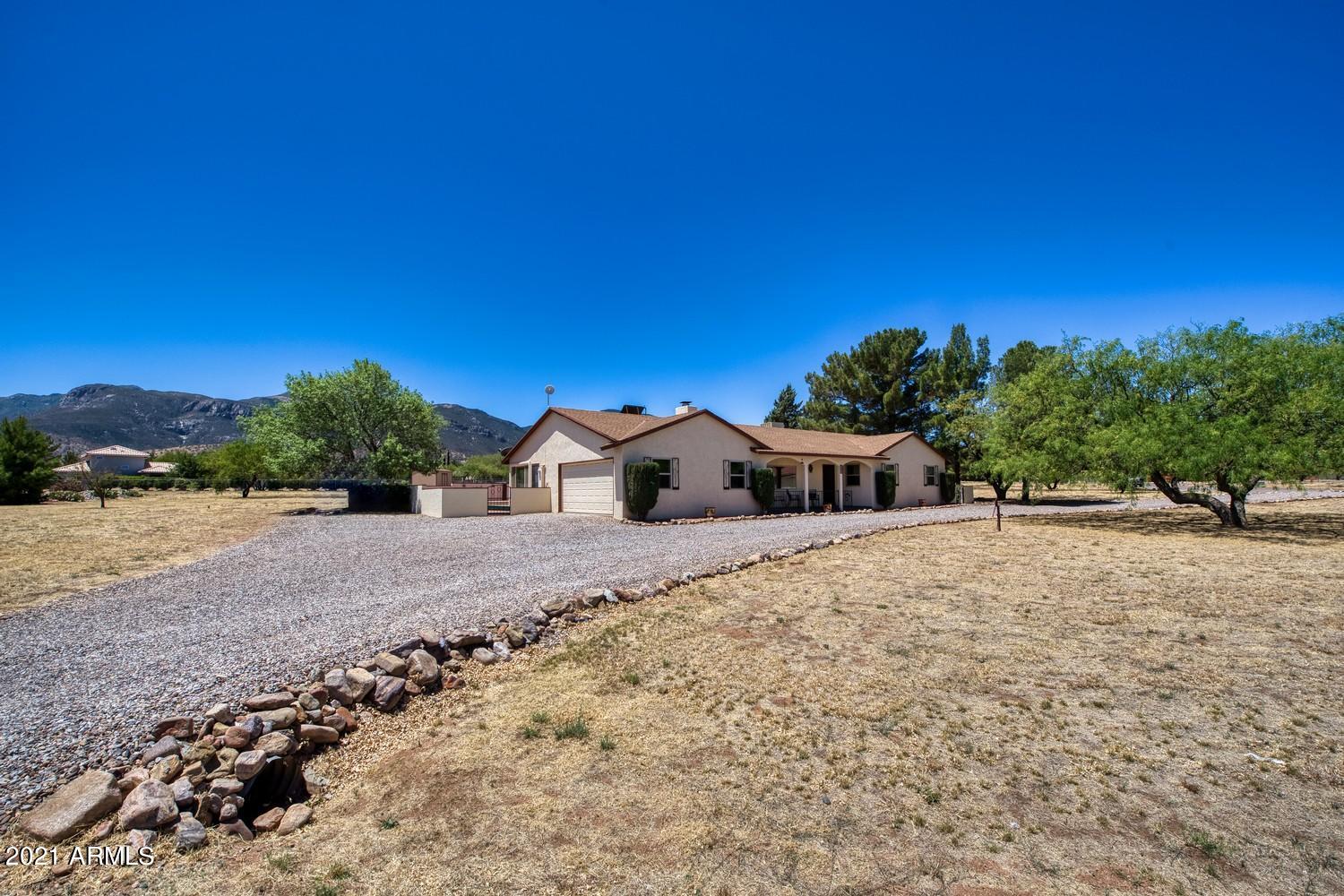 Looking for views of the majestic Huachuca's?  This property has it all!  This 3 bedroom 2 bath home, has a large living room with beautiful wood burning fireplace.  Gorgeous wood laminate flooring that is brand new.  New carpet in the bedrooms.  This is an all electric home which would be perfect for solar.  The entire back of the home has 2 Arizona rooms with windows looking out to the Huachuca's.  The fenced portion of the backyard is big enough for a pool.  In the evening sit on the front porch and enjoy the peace and quiet and star filled nights.  Call today to view!