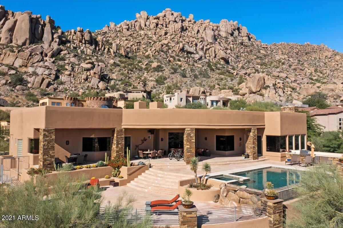 Impressive Troon Ridge Estates home featuring exceptional 360 degree views with a gorgeous negative edge pool & spa to enjoy! Open floor plan with 4 bedrooms, 5.5 bathrooms plus an office. Chef's kitchen with gas Wolf appliances and grand island for entertaining. Come fall in love with the beauty of Troon!