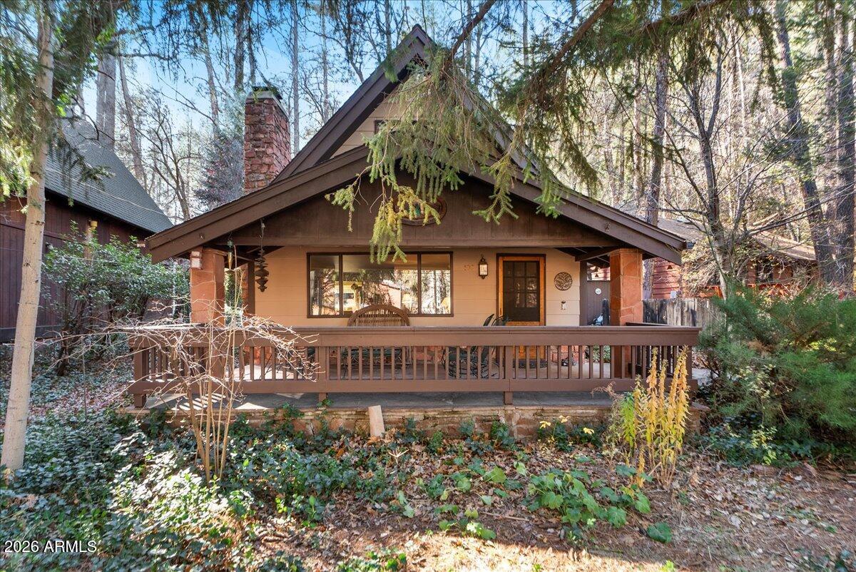 This four-bedroom, two and a half bath Cabin in Oak Creek Canyon's Pine Flat Subdivision is more than a home. It's an opportunity to enjoy beautiful four seasons in solitude or with friends and family. Relax on the large front porch surrounded by tall pines and watch nature show off amazing birds, beautiful flowers and more.  Create lasting memories in a place where you can truly unwind. A private trail leads into the National Forest and drops down to Oak Creek. Pine Flats has community events for everyone to enjoy. This two-story cabin has the primary bedroom downstairs with three additional bedrooms upstairs. Spacious living room with fireplace for hanging out on those chilly evenings. Put your personal touches on this cabin to make it your own and start making lifelong memories.