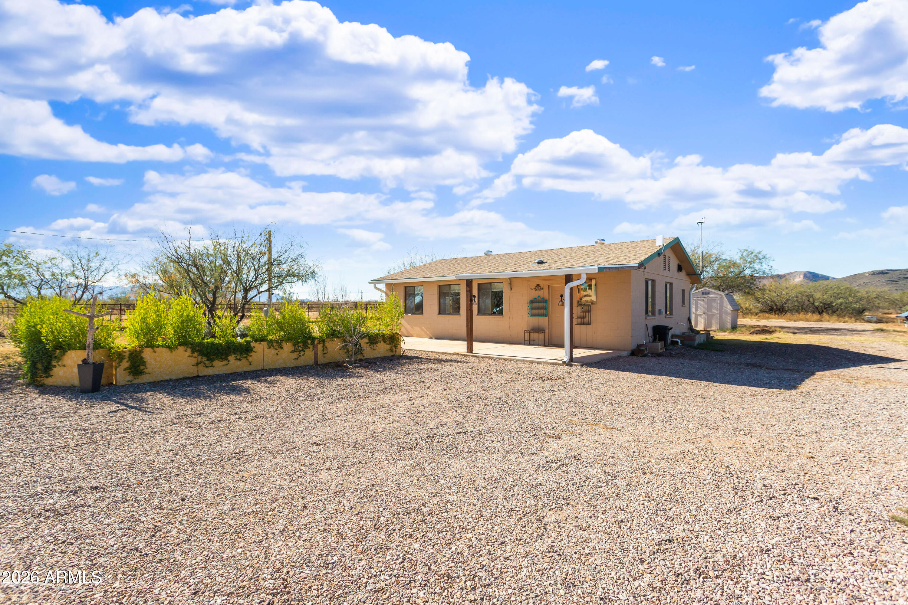 Enjoy sweeping views of the Whetstone and Huachuca Mountains from this ideally located 16-acre property near Sonoita wine country, Tombstone, and Sierra Vista. Situated on four conjoining parcels along a county-maintained paved road, the property offers excellent access and privacy. The split-block home was converted in 2024 from an oversized garage and features Southwest style, covered porch with shaded courtyard and drip irrigation, an open floor plan, laundry room, oversized bedroom, and large closet. Property improvements include a four-bedroom septic (2022), 30'x36' shop, fenced acreage, corrals, animal shelter, automatic livestock waterer, solar water panels, garden beds, sheds, and room to expand. Property has potential for mixed use/commercial zoning.  Buyer to verify.