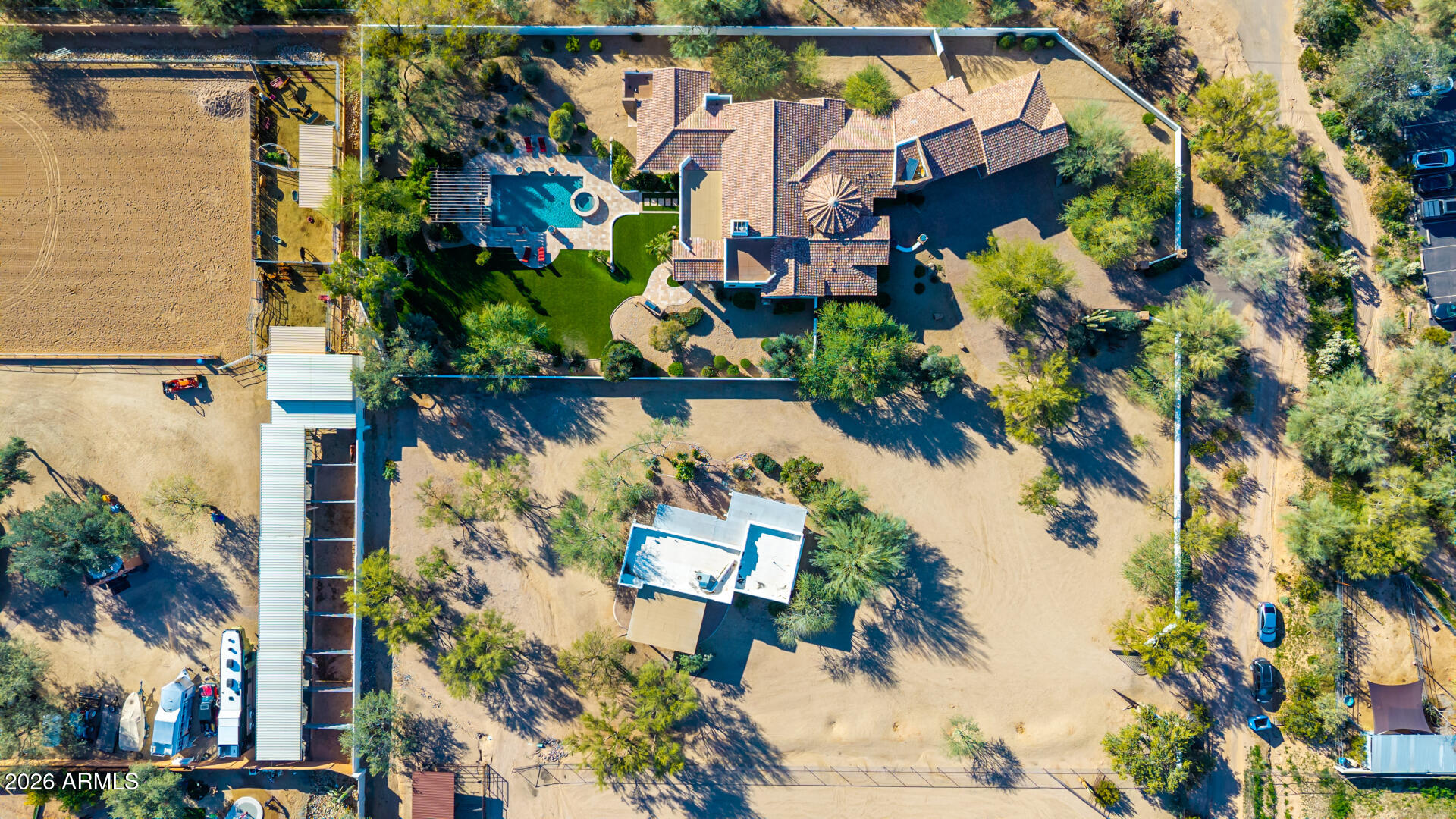 This listing is for the Main House + Guest House only. Please see MLS#6971415 & MLS#6971325 for additional configurations for the Main House only OR the Main House + Guest House + Vacant together. 

NESTLED on an oversized corner lot & featuring 4,666 sq ft with a stunning façade w/ tasteful stone accents, a manicured low-care landscape, a 4-car oversized garage w/ built-in cabinets, and a circular paver driveway. Come inside to discover a welcoming circular foyer, which flows seamlessly into a spacious great room showcasing high ceilings w/ exposed wood beams, a wet bar, and an impressive fireplace to keep you warm during the cold winter months. Travertine stone flooring, dazzling light fixtures, and neutral palette throughout! The gourmet kitchen is worthy of a chef, equipped w/ ample cabinetry, a walk-in pantry, granite countertops, honeycomb tile backsplash, SS appliances, and a center island w/ a breakfast bar for casual dining. The kitchen includes 2 dishwashers, 1 subzero refrigerator, and 1 Wolf double oven. If you like entertaining, you will love the dining area that is conveniently located off the kitchen where you can enjoy formal meals with family or friends in style.  

You'll be amazed by the grand master bedroom, with plush carpet, a huge walk-in closet with built-in shelving and washer & dryer hookups, a 2nd fireplace, and a lavish ensuite bathroom w/ dual vanities, a large tiled shower,  plus a jetted tub. The secondary bedroom can be used as a mother-in-law suite or second master bedroom with a separate entrance to the backyard with  its own private bathroom as well as a dry bar.  The remaining 2 bedrooms are ample size with their own private bathrooms.  There is a separate laundry room inside with plenty of storage and a utility sink. 

Outside, you will find a huge resort-style backyard including a covered travertine patio & decking, extended seating areas, nice size grassy area for outdoor sports, a built-in BBQ area, a lovely pergola, a sparkling blue pool, and a refreshing spa. 

Separate guest house included in this listing features 2-bedrooms, 2-bathrooms, 2-carport spaces, plus its very own living room and kitchen w/ blue glazed tile countertops and Saltillo tile throughout. There is paver parking under the carport.  The washer & dryer will convey. Interior paint (2024) & exterior paint (2026). The backyard is very spacious and is adjacent to the main house to the west & vacant land to the east. A designated septic system is included with the guest house. 

The main house includes 4,666 square feet APN# is 211-44-070-C. The guest house includes 1,160 square feet APN# is 221-44-070-B.

All three MLS#6971383, 6971325, and 6971415 must be sold as specified on MLS. No portion of the listing can be sold separately other than the main house.