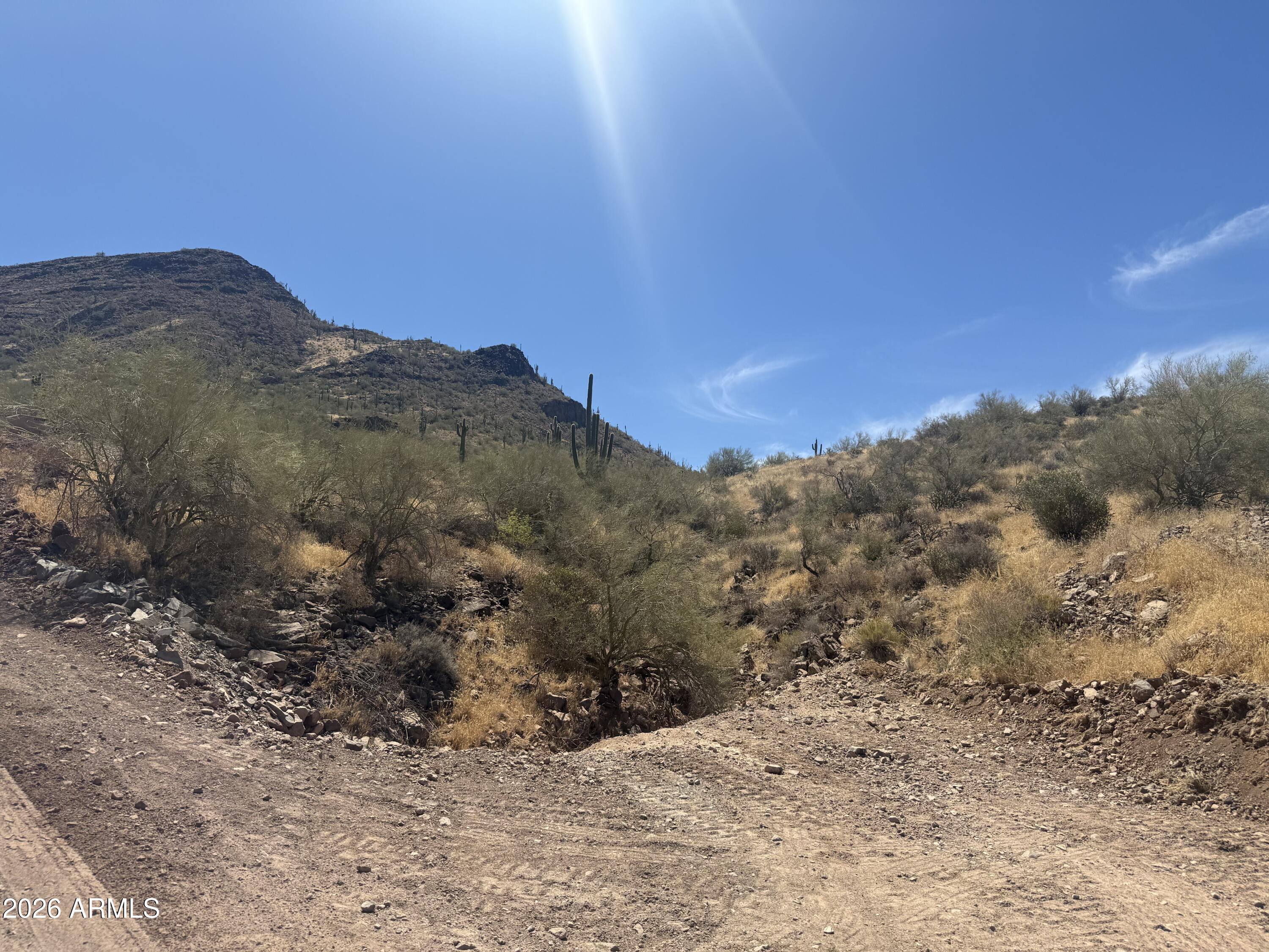 Tucked away in one of New River's most private valleys, at the base of Apache Peak, this property feels like it was carved out just for those who value space, beauty, and stillness. With sweeping mountain views and direct access to thousands of acres of State Land and the Maricopa Trail, it offers the rare balance of seclusion and adventure. Set on 5 acres this piece of land is ready for your custom home vision.