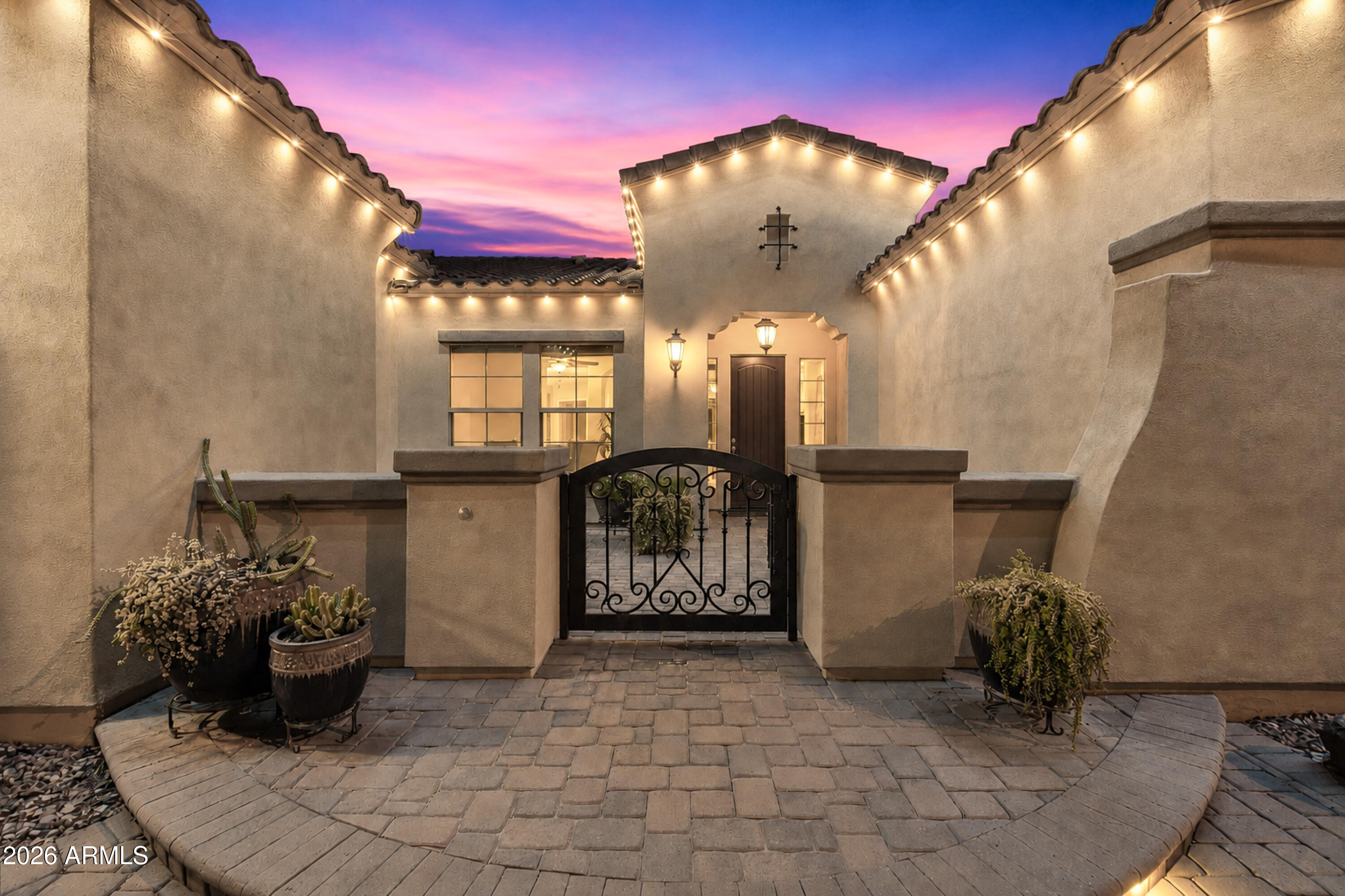 Welcome to luxury living in Gilbert's sought-after Bridges community! This beautifully designed home offers 3 bedrooms, 4 bathrooms, and a spacious 3-car tandem garage. The open floor plan features a stunning great room with wood-beamed ceilings, custom fireplace, and seamless flow into the gourmet kitchen with granite countertops, oversized island, rich cabinetry, and premium finishes. The luxurious primary suite boasts a spa-inspired bath with soaking tub, oversized walk-in shower, and elegant details. Step outside to your private backyard retreat featuring travertine pavers, built-in fire pit, lush landscaping, tranquil water feature, and low-maintenance turf. Close to parks, trails, shopping, dining, and top-rated Gilbert schools.