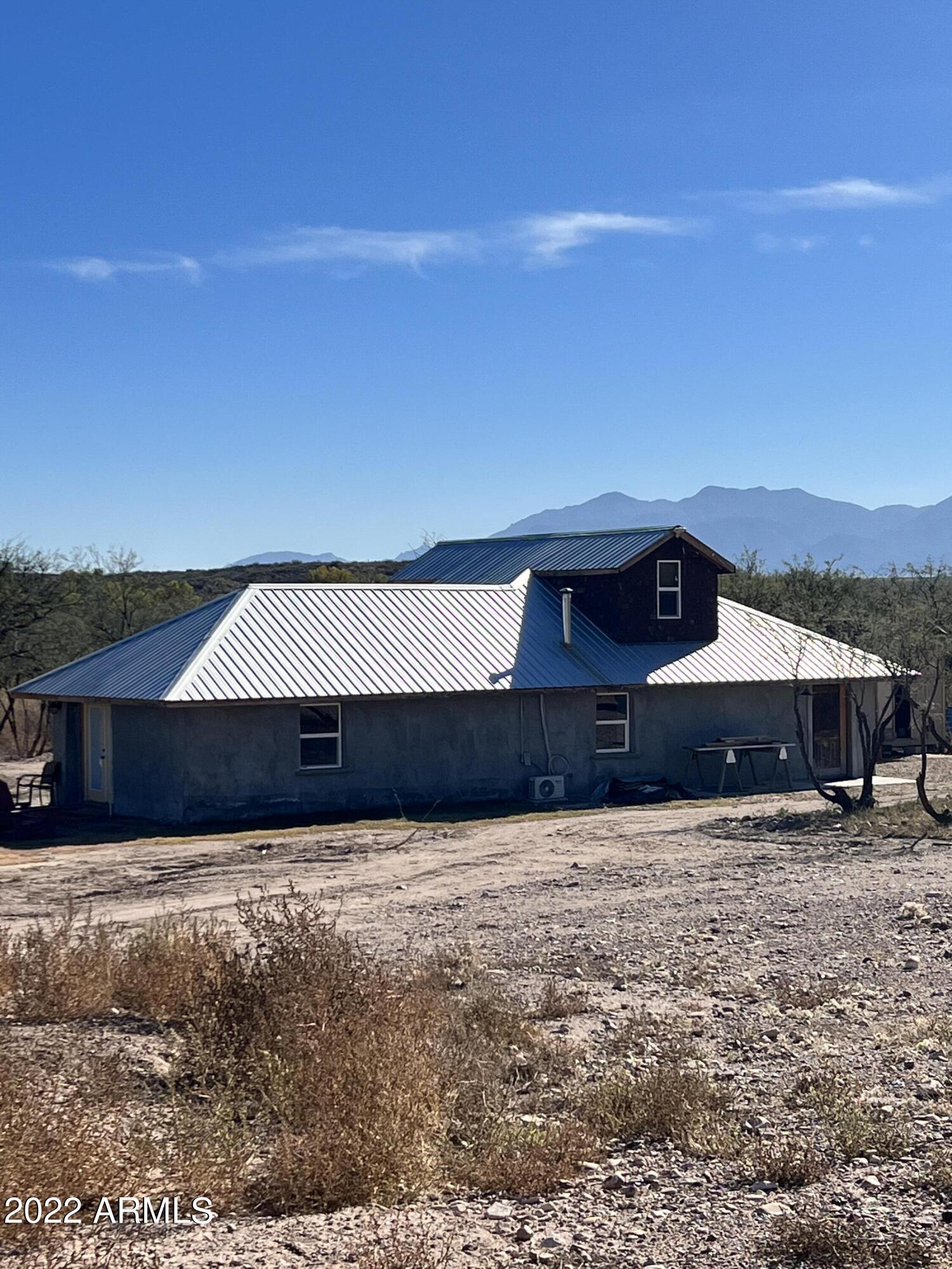 Off grid living at its finest! This 3bed/1bath rammed earth home includes all of the amenities needed for self sustained living. Solar panels provide electricity to the entire property. 360 degrees of beautiful mountain views. Primary downstairs bedroom with additional guest bedrooms upstairs. Close proximity to Babocomari river.