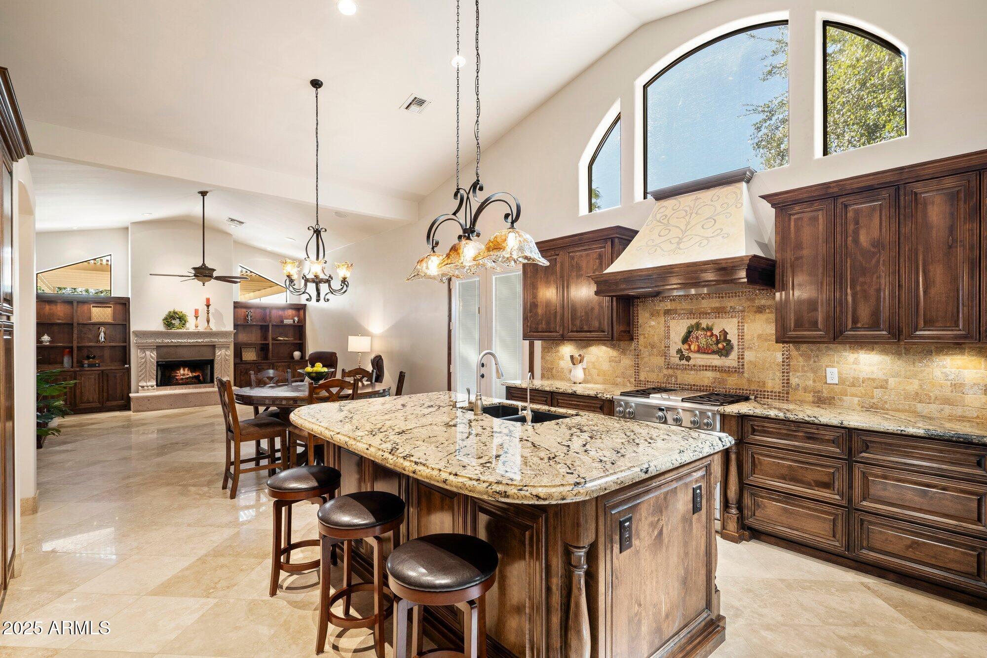 CIRCLE G CUSTOM HOME-Perfect for Indoor and Outdoor Entertaining.  Nestled on over 3/4 Acre. Offering 4 Bedrooms Plus a Bonus Room that can be used as an Office or Flex Space.  Luxury Custom Cabinets, Granite Countertops, Travertine Flooring with Mosaic Inlays, Wood Flooring (no carpet), Stained Solid Wood Doors, 2 Cantera Surround Fireplaces, Primary Suite with Stunning Stone Walk-In Shower and Rain Head, Gourmet Kitchen with 36'' Professional Grade Propane Stove, Electric Oven, Wall Oven/Microwave, Wine Fridge, Built-In GE Monogram Fridge, Custom Hood. Enjoy Outdoor Kitchen with Green Egg Smoker, Mini Fridge and Rotisserie Grill, Spacious Patio with Misting System and Pergola. Refreshing Pool with Water Feature, Separate Heated Spa. RV Gate, Spacious Parking, 3 Car Garage with Cabinets. Additional features include Soft Water System, Smart Thermostat, Home Security System and Freshly Painted Interior/Exterior.  A Luxury Home Designed for Comfort, Style and Unforgettable Gatherings.