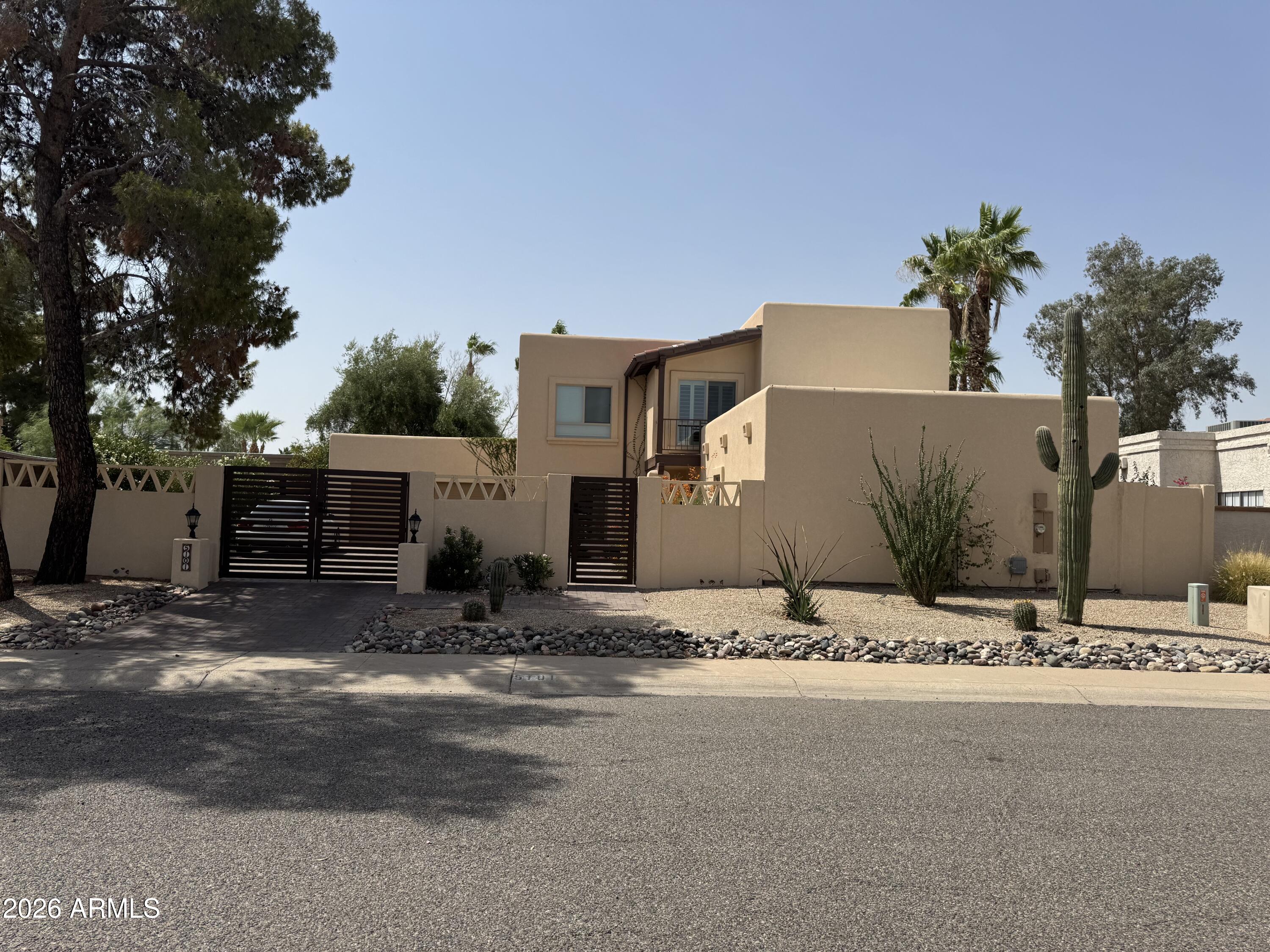 Don't miss this rare opportunity to own a beautiful home in the sought after Santiago subdivision of Scottsdale's coveted 85254 zip code. Designed by renowned architect Bob McIntyre, known for creating the iconic Tlaquepaque Arts & Shopping Village in Sedona AZ. This turnkey property is nicely updated and has been operating as an active short-term rental without Scottsdale's restrictive guidelines. Sellers are willing to include all furnishings with the right offer! Ideally situated near premier shopping, golf courses, the Mayo Clinic, and within walking distance to parks and schools. Drive through the modern gates into a charming private courtyard with a beautiful fountain. Inside, you'll find the perfect tile flooring, vaulted ceilings, and updated energy efficient windows throughout. The gourmet kitchen features granite countertops, stainless steel appliances, and a breakfast bar perfect for entertaining. The main-level primary suite provides comfort and privacy, while upstairs offers a spacious loft, two additional bedrooms with bamboo flooring, and a Jack-and-Jill bathroom. The two-car garage includes built-in cabinetry and epoxy flooring. The resort-style backyard is your own private paradise featuring an outdoor kitchen, easy to maintain artificial turf, mature fruit trees, travertine pool decking, and a diving pool designed for Arizona living at its finest.