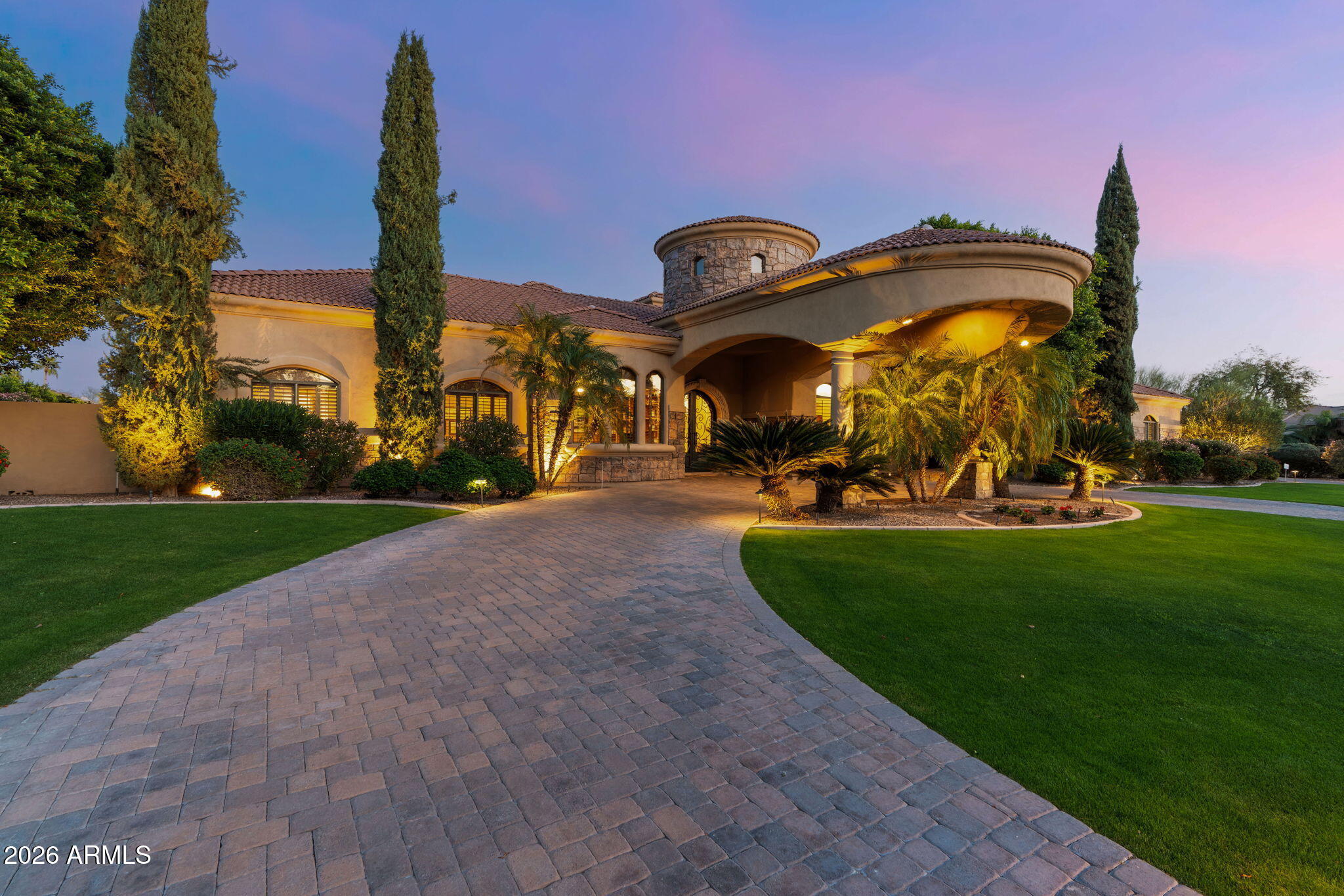 This expansive and exquisite estate sits on ¾ of an acre, framed by spectacular McDowell Mountain views and natural open space along the rear and side of the property, creating a rare sense of privacy and a tranquil setting in North Scottsdale.

Located within Rancho Santa Fe, an exclusive gated luxury enclave of just 14 custom homes, this residence offers 5,500+ square feet of thoughtfully designed living space with 4 bedrooms and 3.5 baths, complemented by a double office, elegant wood-paneled game room, dedicated exercise room, and a kids' flex space that seamlessly connects the three secondary bedrooms. Car enthusiasts will appreciate the 1,500+-square-foot, 4-car garage, featuring abundant built-in and functional storage, a workbench, and an additional 170-square-foot dedicated storage room, ideal for collectors, hobbies, or active lifestyles.

Designed for both comfort and functionality, the home features a well-executed split floor plan anchored by a spacious primary suite overlooking the resort-style backyard and accented by an elegant fireplace. The primary bathroom serves as a private retreat, offering an oversized walk-in closet, dual vanities, a jetted soaking tub, and a walk-in shower, along with direct access to the adjacent exercise room and the backyard.

The home offers both formal and informal living spaces, including a formal living room with fireplace and an elegant formal dining room ideal for entertaining or quiet gatherings. The great room, which seamlessly incorporates the kitchen and bar, also features dining space and a fireplace, creating a central hub for everyday living and entertaining.
At the heart of the residence is a gourmet chef's kitchen, thoughtfully upgraded with top-of-the-line stainless steel Thermador appliances, including side-by-side refrigerator and freezer, double ovens, and built-in climate-controlled wine storage. Additional features include a gas cooktop, two dishwashers, two additional sinks (prep and bar), a kitchen beverage refrigerator, warming drawer, full wet bar with wine fridge, and a walk-in pantry, delivering exceptional functionality for both daily use and elevated entertaining.
The secondary bedroom wing functions as its own private retreat. Accessed through a versatile bonus flex space ideal for a homework area, game room, or teen lounge this wing includes three secondary bedrooms. One bedroom is en-suite with direct access to the backyard, while the remaining two share a bath/shower configuration, each with its own private vanity area.

The office is truly impressive, featuring floor-to-ceiling custom built-ins and offering ample space for two separate work areas, along with a walk-in closet and a coffee and beverage station, making it ideal for remote work or dual professionals. 
The property enjoys McDowell Mountain views, a desirable north-east facing orientation, and a paver circular drive leading to a side-entry garage, providing ample additional parking for guests, recreational vehicles, or car enthusiasts.  

The resort-style massive flat backyard is designed for both relaxation and recreation, featuring a heated pool and spa with upgraded lighting, sport/pickleball court, a recently renovated large artificial turf grassy area ideal for kids or pets and a generous putting green, plus a thoughtfully designed vegetable and herb gardenideal for farm-to-table living, all complemented by a large covered paver patio with fireplace. A fully equipped outdoor kitchen with outdoor refrigerator makes entertaining effortless while enjoying mountain views.

Neighborhood amenities include walking paths, a community playground, grassy open play areas, and BBQ gathering spaces. Ideally located near Arizona's top schools, including BASIS and Scottsdale Unified, as well as The Mayo Clinic, with convenient access to the Loop 101 and approximately 20 minutes to Sky Harbor International Airport, this home offers a rare combination of space, privacy, storage, and true indoor-outdoor living in one of North Scottsdale's most desirable gated communities.