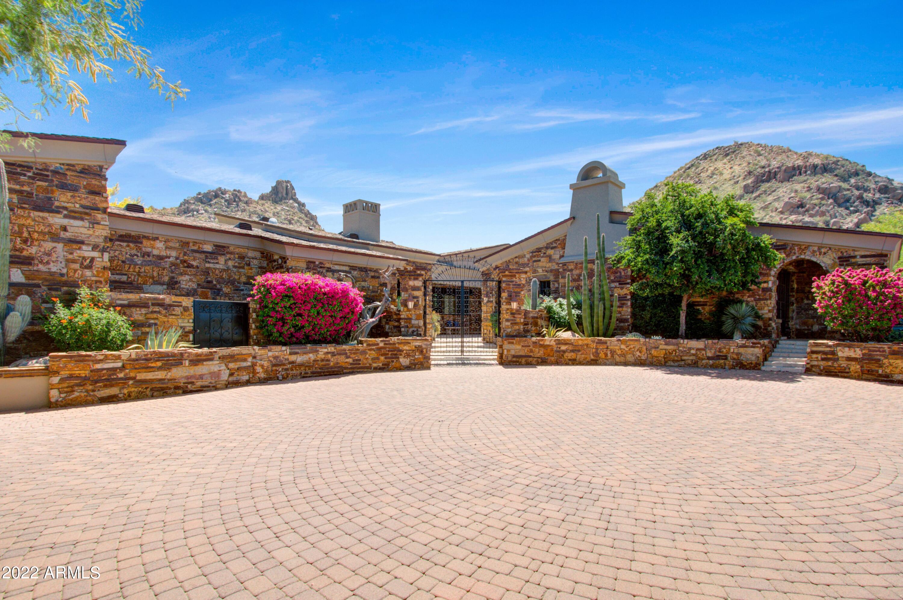 Elegant remodeled santa barbara inspired home by Bob Bacon with expansive Pinnacle Peak and golf course views in Estancia * Open, Great Room floor plan with soaring ceilings that frame massive Hope Steel windows to views * Large master suite with exercise studio and exceptional walk-in closet * Separate entrance guest house includes a living room with wet bar and bedroom with bath * Interior materials include Italian limestone flooring, Alder wood covered ceilings, Venetian plaster wall finishes and granite and quartzite slab counter surfaces * Exterior materials are a rich blend of stacked stone, formed concrete, slate, wood and steel * Outdoor living includes a heated pool and spa, covered dining patio, gas fireplace and outdoor kitchen * The over-sized 3-car garage is climate controlled * A rare opportunity for Estancia Golf Membership, buyer must complete all member requirements and subject to board approval.*