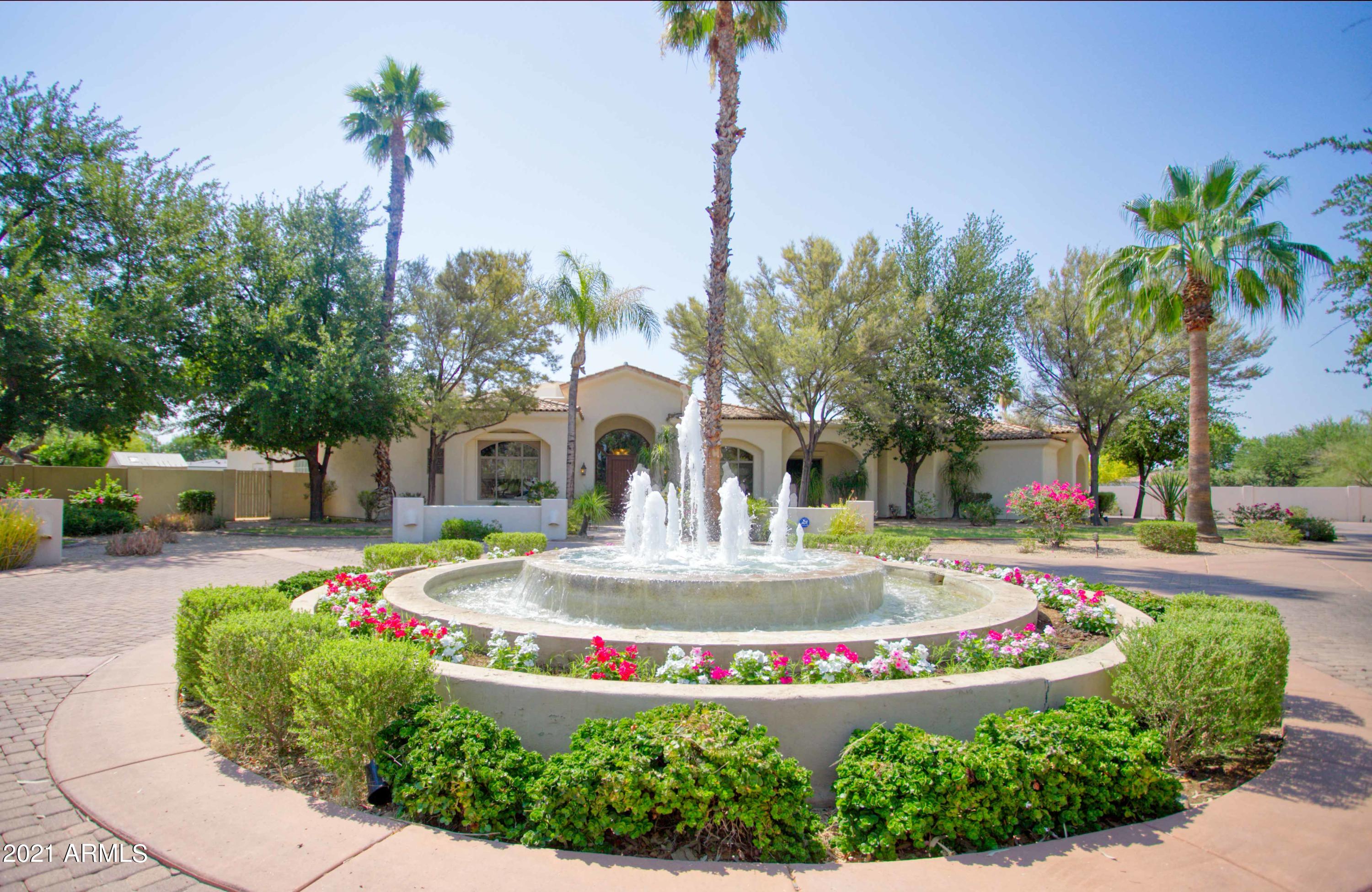 Gorgeous home in an exceptional Paradise Valley location. Drive in to the gated entry with a tranquil fountain. Enter through the foyer with views directly to your backyard paradise that is just shy of an acre. The living room impresses with wall to wall pocket doors that lead directly to your entertaining patio. The split floorplan features stone and wood flooring throughout and 5 en-suite bedrooms with walk-in closets. The grand chef's kitchen is highlighted by the center island, bar seating, 2 of almost every appliance, butler's pantry, and overlooks the family room and wet bar. The private master suite is complete with luxurious master bath, sitting area, exercise room or office, fireplace, his and hers closets. The lush backyard offers multiple entertaining areas, The lush backyard offer multiple entertaining areas, pool, spa, flowing water fountain, built-in BBQ, and outdoor kiva fireplace. The oversize 4 car garage has built-in cabinets and room for all the toys. This is truly an outstanding property with comfort, amenities, and privacy in one of the best locations in town.