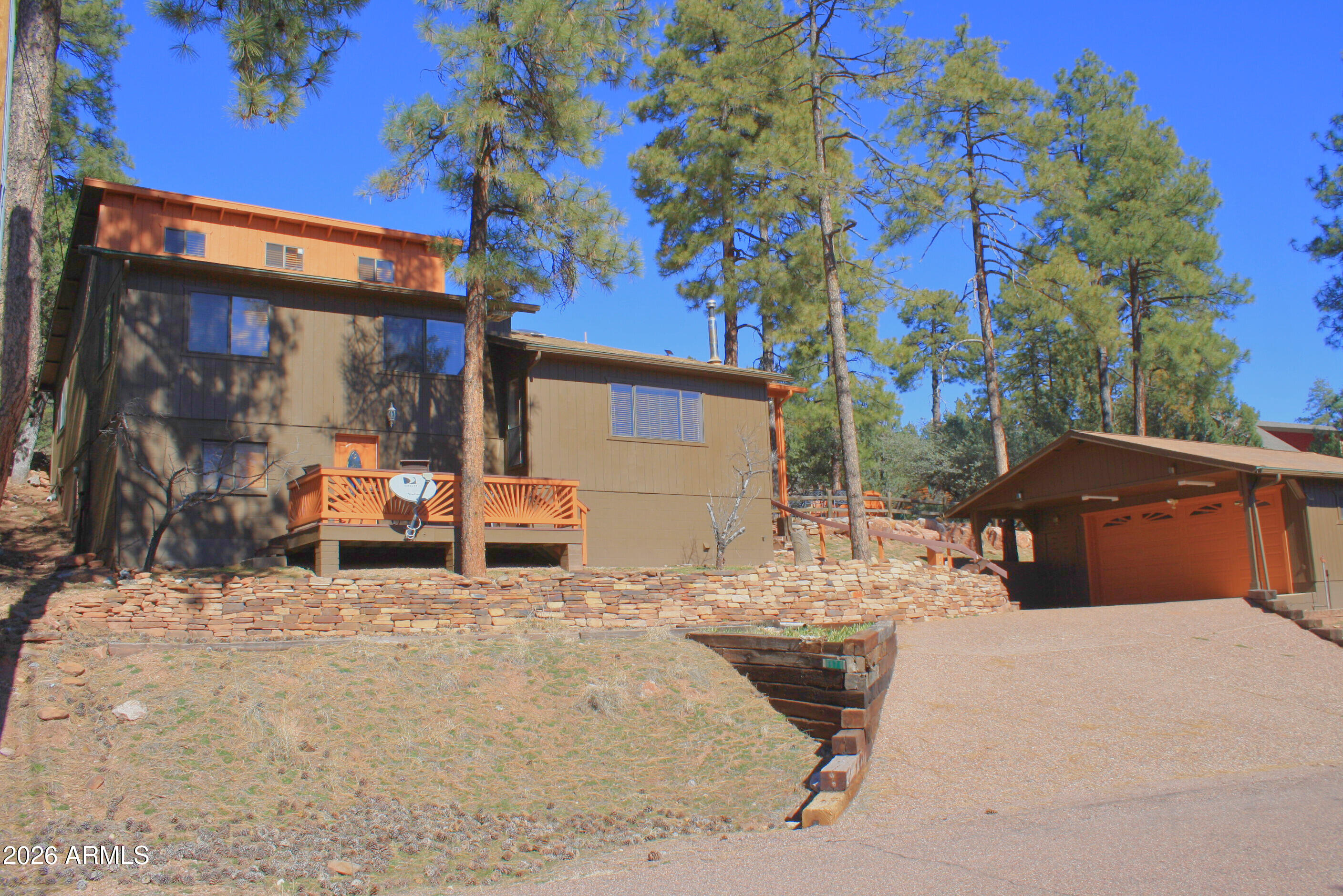 Welcome to 6670 W Jan Dr, a generously sized, well-appointed residence nestled in the cool pines of Pine, AZ. This 3-bedroom, 3-bath home boasts 2,428 sq ft of living space across multiple levels, offering flexibility and comfort for everyday living and entertaining. The main living area features a gas-log fireplace with tongue-and-groove wood-lined ceiling, while the bright and open kitchen/dining area seamlessly transitions to an inviting covered deck complete with a spa—perfect for outdoor enjoyment and relaxation. The main level includes the primary suite and a guest bedroom, with an attic space that serves as an additional sleeping area perfect for the kids, guests or an office.  Currently being used as a successful AirB&B, this is the one you have been waiting for as an investment or to use as your own personal private getaway! The lower level provides a charming rec room with kitchenette, extra bedroom and bath, large laundry, and abundant storage. Additional highlights include a detached heated garage with workshop space, forest and Rim views, and separate driveway access. Situated on a wooded .33-acre lot, this property combines privacy with convenience to local amenities and outdoor recreation. Now is your time and this is the one!!