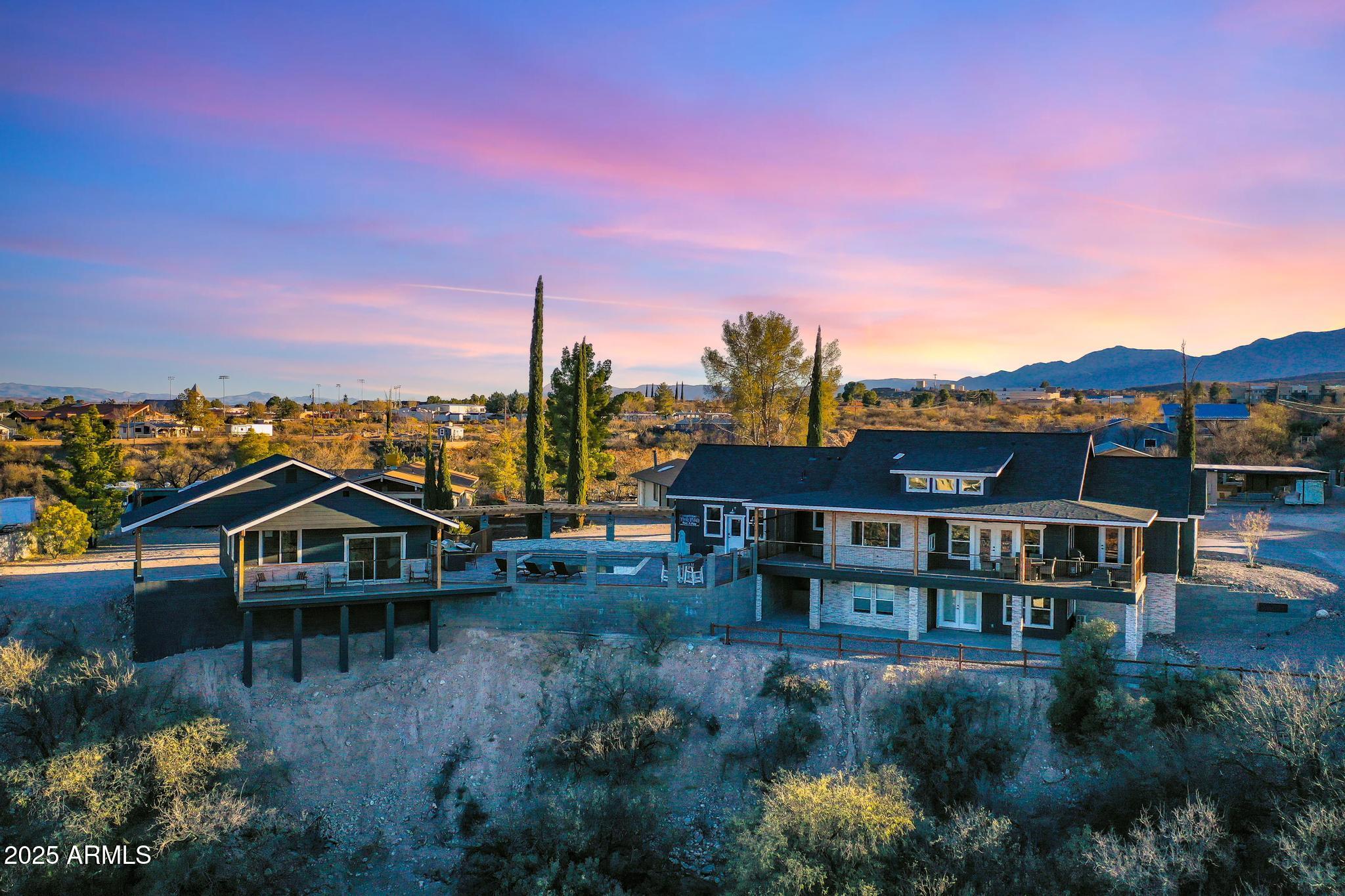 Experience luxury redefined: don't sacrifice comfort, design, or location. Enjoy it all in this once-in-a-lifetime property perfectly situated in the heart of Old Town Cottonwood, directly across the street from Merkin Vineyard. Built by local builder Joe Mulcaire Contracting, this home showcases the signature craftsmanship and timeless style their work is known for.

This 4-bedroom, 3-bathroom residence features a thoughtful split floor plan and an open-concept design that invites both comfort and charm. The chef's kitchen immediately captures your attention upon entry, highlighted by an oversized window framing Merkins' picturesque vines. Custom cabinetry, generous counter space, luxury appliances, granite countertops, and luxury vinyl plank flooring complete this stunning culinary space.

The primary suite is a private retreat, featuring a spacious sitting area, direct access to the covered deck, dual walk-in closets, and an oversized walk-in shower. Throughout the home, shiplap accents, custom woodwork, and a handcrafted fireplace hearth add warmth and character.

A separate pool house extends the property's appeal, fully equipped with its own kitchen and laundry room. Butcher block countertops, shiplap walls, and a tiled walk-in shower echo the same elevated finishes found in the main home.

Step outside to the exterior spaces that are every bit as impressive as the interior, offering generously sized covered decks, an outdoor kitchen and BBQ area, a stunning pool, and sweeping panoramic views.

Currently operating as a successful short-term rental, this property offers endless possibilities: make it your full-time residence, a luxurious vacation home, or continue earning income while enjoying personal stays whenever you choose. It is selling fully furnished, with future bookings, if the buyer would like.

Don't miss this rare opportunity to own a home that blends luxury, location, and lifestyle, just steps from Cottonwood's best tasting rooms, dining, and entertainment, while still offering all the tranquility of a private retreat.

Upgraded Energy Efficiencies
NO HOA