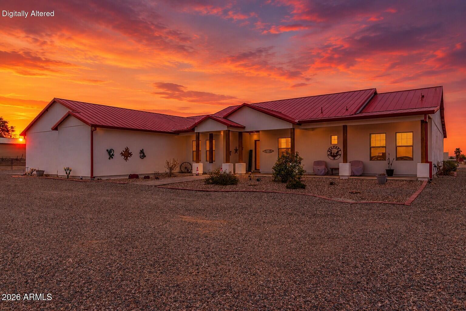 Welcome to your Arizona ranch dream! This exceptional 4-bedroom, 3.5-bath custom home offers the perfect combination of luxury, functionality, and country living on a beautifully designed horse property in the desirable Buckeye countryside. Whether you're an equestrian, animal lover, or simply looking for room to spread out, this property has it all. Inside, you'll find a spacious, open floor plan filled with natural light and designed for comfortable everyday living and entertaining. The well-appointed kitchen flows seamlessly into the main living areas, creating an inviting space for family gatherings and special occasions. The generous primary suite offers a peaceful retreat with a private bath, while three additional bedrooms and multiple bathrooms provide plenty of room for family. Step outside and experience your own private backyard oasis. Cool off in the sparkling swimming pool, relax under the covered patio, and enjoy breathtaking Arizona sunsets with wide-open desert views. Every inch of this property has been thoughtfully designed to embrace the outdoor lifestyle. Equestrian enthusiasts will appreciate the impressive ranch amenities, including covered horse stalls, a roping arena, and ample room for riding and training. Pet owners will love the air-conditioned dog kennel, providing year-round comfort for your four-legged companions. The property also features extensive farm equipment parking, with plenty of space for RVs, horse trailers, tractors, and recreational vehicles. Located just outside the city, this property offers the peace and privacy of rural living while remaining conveniently close to shopping, dining, schools, and easy access to the Phoenix metro area. Whether you're searching for a working horse property, a family ranch, or a private country retreat, 5604 S 225th Ave delivers an exceptional lifestyle with room to live, work, play, and grow. Don't miss this rare opportunity to own a one-of-a-kind Buckeye estate where comfort, recreation, and western living come together. Schedule your private tour today!