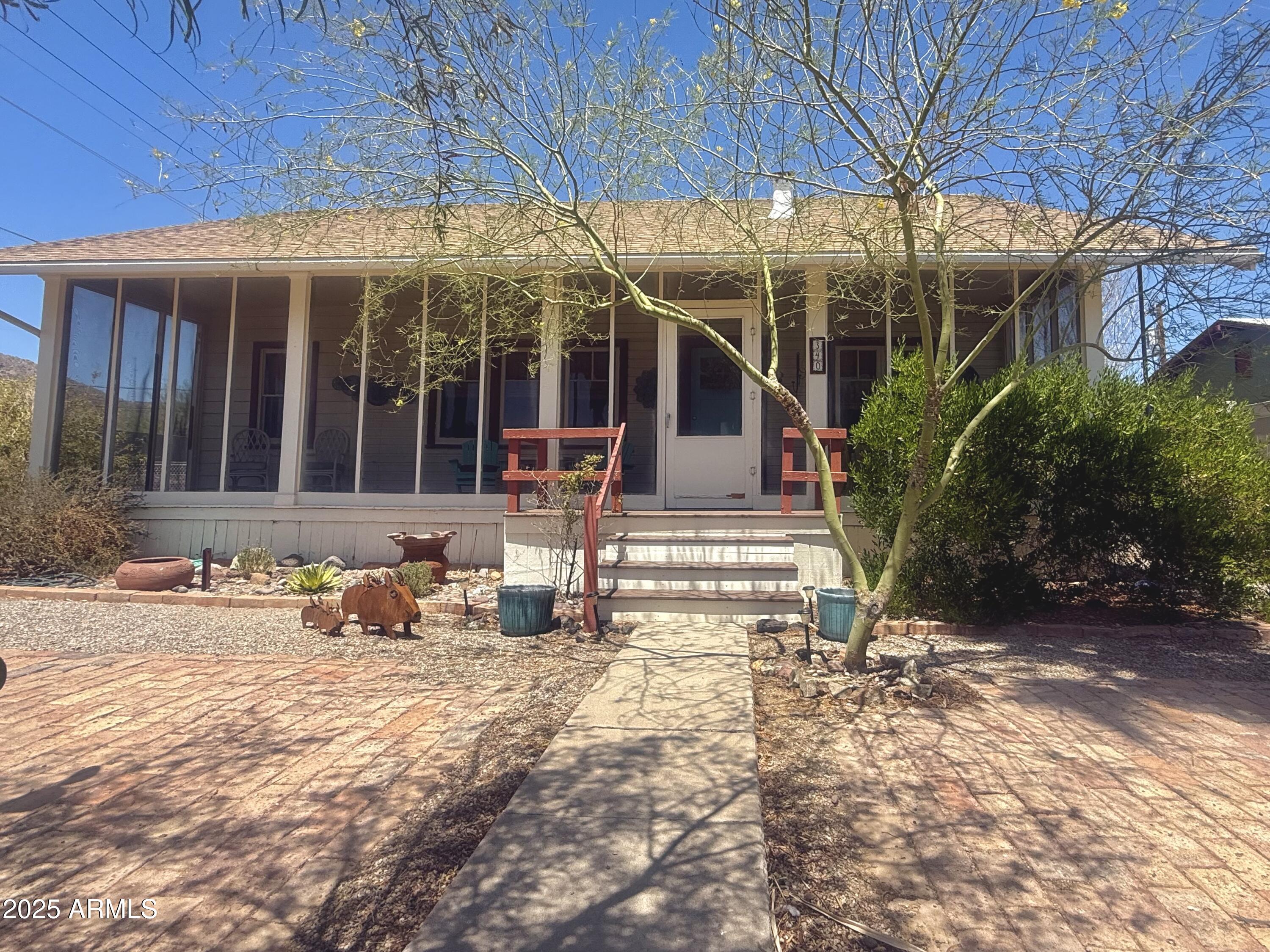 This charming home built in 1919 offers 2-bedrooms, 1.5-baths with plenty of historic character and modern updates—all just steps away from the Plaza and Curley School! Featuring original hardwood floors, screened in front porch, mature desert landscape, tall ceilings, and recent upgrades including a new roof (2022), updated bathroom, fresh paint, mini-split system, and new dishwasher.

Out back, enjoy a fully insulated and air-conditioned detached garage/workshop—perfect for a studio, office, or creative space. 

The backyard is complete with two RV gates and hookup with covered patio and garden.

Whether you're an artist, a maker, or simply someone who appreciates character and craftsmanship, this one-of-a-kind home is waiting to inspire you.