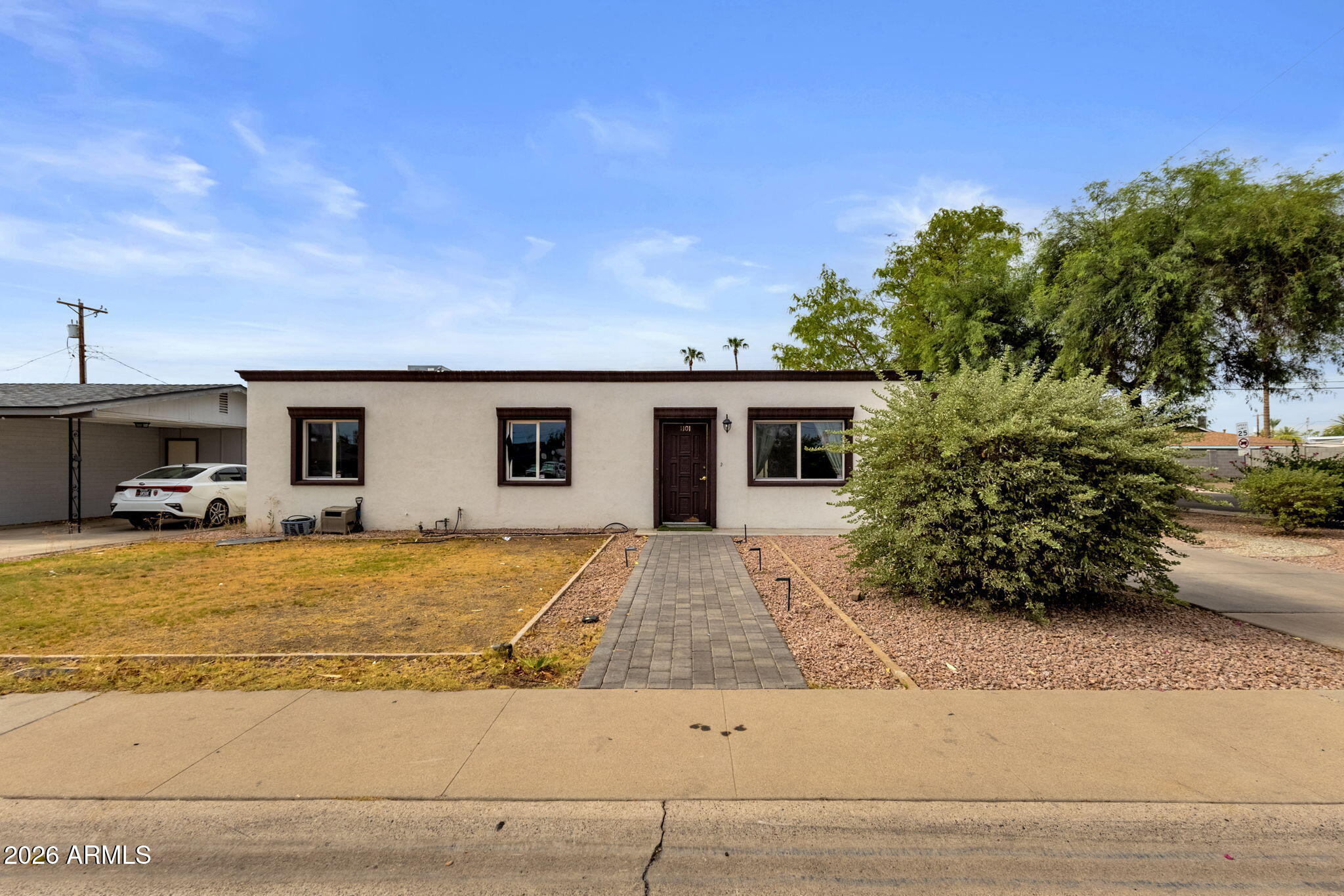 Opportunity awaits in Tempe! This 4-bedroom, 2-bath home sits on a spacious corner lot and offers 1,428 sq ft of comfortable living space with endless potential. The functional floor plan provides generous living areas, while the large lot offers room to personalize, entertain, or create your ideal outdoor retreat. The front and backyard landscaping have both been professionally designed. Updated kitchen with red cabinets, granite countertops, stainless appliances and white tile backsplash. All bathrooms have been remodeled and have tiled showers, tile flooring, and dual pane windows installed. Located just minutes from Arizona State University, Tempe Town Lake, Old Town Scottsdale, Phoenix Sky Harbor Airport, shopping, dining, parks, and major freeways, this home is perfectly positioned for homeowners, students, or investors. Whether you're searching for a primary residence, rental property, or value-add opportunity, this North Tempe home combines location, convenience, and potential.