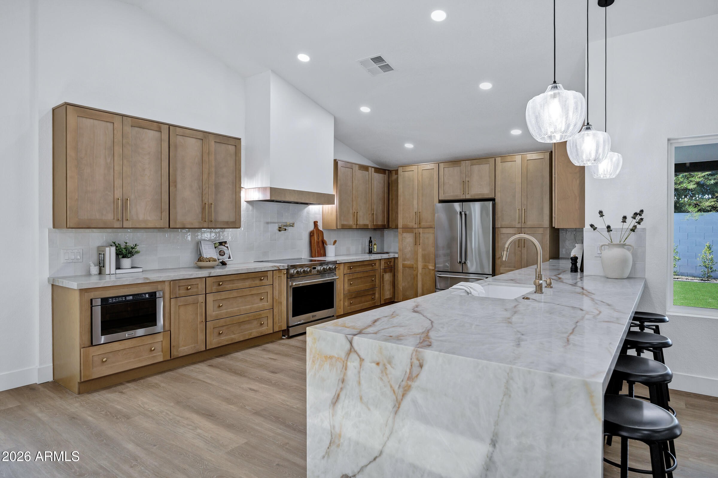 Welcome to this beautifully fully remodeled Mesa home where modern design meets everyday comfort. From the moment you walk in, you'll notice the bright open layout, designer finishes, and attention to detail throughout. Features include brand new LVP flooring, stunning quartz countertops, custom cabinetry, fully remodeled bathrooms, upgraded fixtures, and a chef-inspired kitchen perfect for entertaining. The spacious backyard has been completely refreshed with newly planted ficus trees, low-maintenance turf, and plenty of room to relax or host gatherings. Conveniently located near shopping, dining, parks, schools, freeway access. This one truly feels like a custom home and is completely move-in ready!