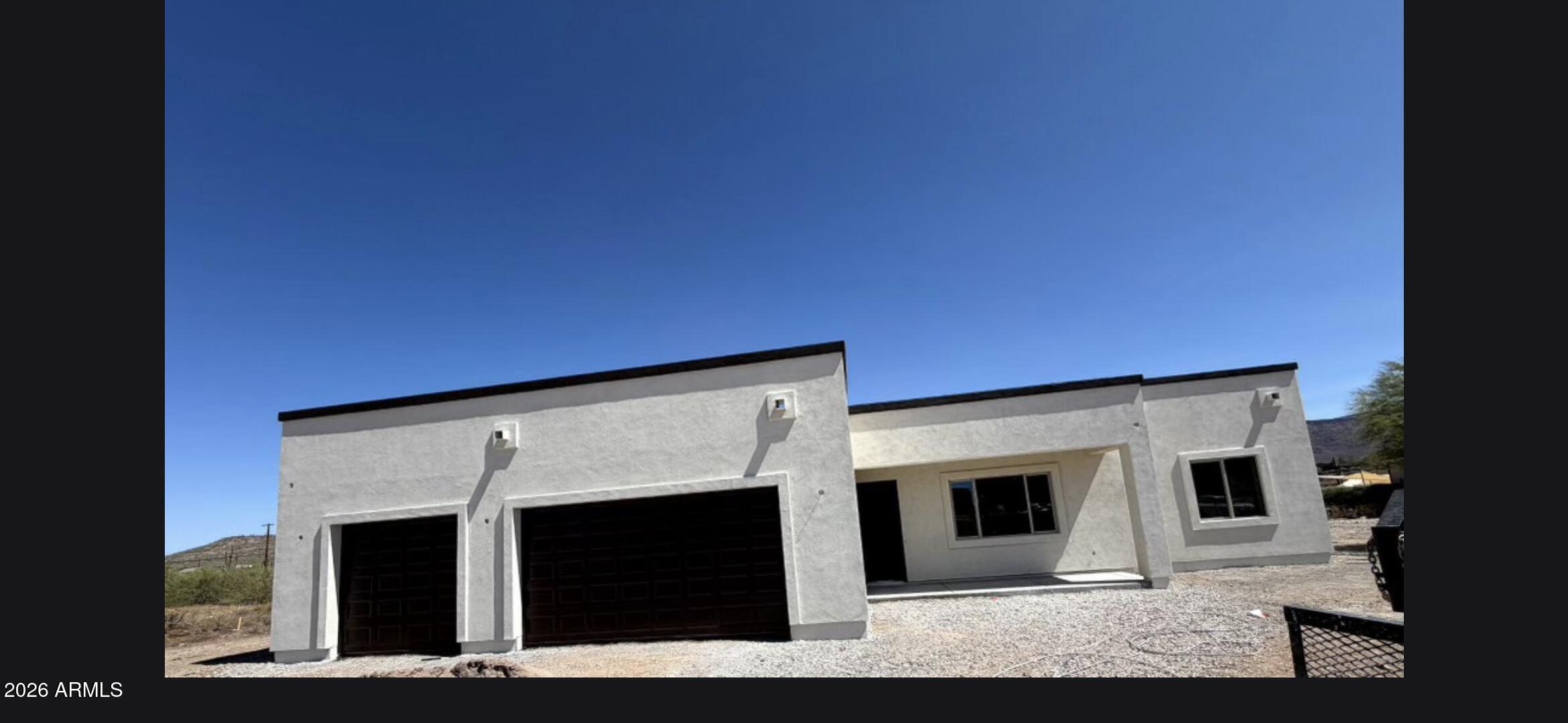 *Wow! NEW High quality Saddle Mountain Home under construction. Completion approx. August 2026.  Some finished photos shown are an example only of a previously built home. Finishes and upgrades may be different than the actual property.  1.212 acre lot*Incredible mountain views * Horse Property* 3 car garage. Open spacious greatroom floorplan* 9x24 Porcelain Wood-look Tile.  (Kitchen, Breakfast, 4' Hall Foyer to Kitchen, Laundry, Bath, Hallway) *Kitchen  features:  Full Overlay Doors shaker style. Self-close Drawers with Dovetail drawer box. 42'' Uppers, Granite tops and under-mount Stainless Single Bowl Sink. GE Stainless Steel appliances. Nice size 18.1 x 14.6 master bedroom with: Double
sinks, and a large walk in closet, Walk in shower with tile surrounds. Interior 10' Ceiling. 2x6 Exterior Walls with Continuous Shear * Super energy efficient home with Foam 6" open cell @ Deck & 5 1/2" open cell @ Walls *Dual Pane, Low E Vinyl Window * 15 SEER Goodman AC unit. Other features include: Upgraded 2 coat sand stucco finish * 80/20 Santa Fe Finish, 3/4 bullnose on the interior. wash basin pre-plumb in laundry room. Phone and cable jacks in all rooms. (Cable wires will be run and ready for dish installation). Two tone Dunn Edwards interior paint. 3.0x8.0 fiberglass entrance door. Soft water loop and extra hose bibs. Garage panel doors with insulation and openers. 3 car garage also features a  wash basin pre-plumb. 1765 sqft livable with 3213 sqft under roof. 39 1/2 foot long covered patio to enjoy those views. Hot water recirculation system pre-plumb.  Flooring, cabinets, shower surrounds, ceiling fans will all be similar to photos of previously built home. Master bath flipped in actual home vs photos******* Builder has 39 years of experience and has managed, designed, and built 10,000+ homes. He will do a lot of things with this home that other builders don't do. Examples include extra concrete in the footers, 3x3 rebar throughout the floor (#3 rebar). extra blocking in the framing for better insulation. You will not find better quality. 2 year structural / 1 year workmanship warranty. Bring the horses or toys!!