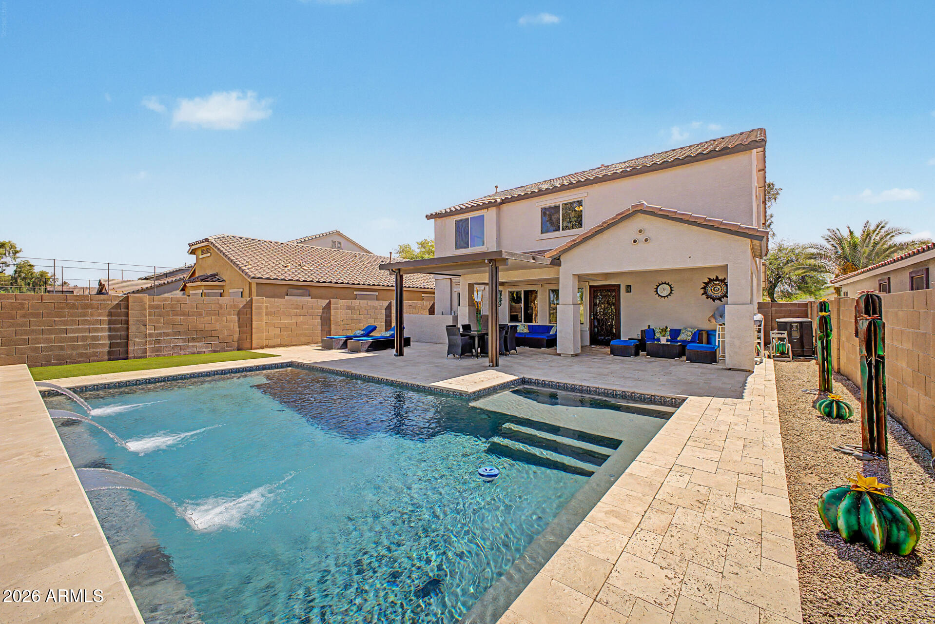 More than $300k in upgrades including a gourmet kitchen with Thermador refrigerator, Thermador drawer microwave and GE Cafe range with double oven (100k), heated pool/backyard retreat (100k), primary bath (40k), two guest bathrooms ($15k each), new windows, HVAC systems and more. Fully updated and situated along the golf course in the Villages at Queen Creek, this renovated six-bedroom home offers the space, upgrades, and backyard lifestyle buyers are searching for. Brand-new windows and fresh exterior paint create standout curb appeal from the moment you arrive. Inside, the remodeled interior features updated finishes, contemporary style, and a spacious layout designed for both everyday living and entertaining. The kitchen opens seamlessly to the main living area, creating a bright and connected space ideal for gatherings. A true six-bedroom floorplan provides exceptional flexibility for multigenerational living, guest rooms, home offices, fitness space, and more. The main level includes formal living and dining spaces, along with a full bedroom and bathroom. Upstairs, the private primary suite features double-door entry, a beautifully updated spa-inspired bathroom, and a custom closet organization system. Major improvements including newer AC systems, windows, water heater, garage door system, iron security doors, and extensive renovations provide peace of mind and true move-in-ready convenience. Out back, the 2021-built heated pool creates a private resort-style retreat overlooking the golf course. Enjoy open views, Arizona sunrises, and a backyard designed for relaxing and entertaining under the pergola year-round. Residents of Villages at Queen Creek enjoy exceptional community amenities including a heated pool, pickleball courts, fitness center, game room with pool table and air hockey, party room available to rent, multiple parks, basketball courts, picnic areas with BBQ grills, and popular community events throughout the year including outdoor movie nights and summer splash events. Conveniently located near Queen Creek Marketplace, Downtown Queen Creek, parks, dining, and schools, this move-in-ready home combines modern upgrades, a rare six-bedroom layout, premium golf course living, and outstanding community amenities.