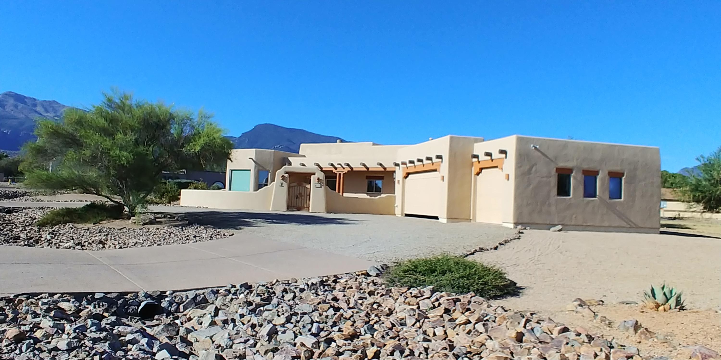 This beautiful Santa Fe style home is so beautiful, but comfortable too. The santa fe style continues thru out the entire home. There is an open beam vaulted ceiling in the living room with a lovely beehive fireplace. It looks out to the lovely landscaped backyard and Huachuca Mountains. The kitchen is well appointed with a custom gas cooktop niche, large island with breakfast bar and wall oven and microwave. There is also a large dining room with lovely view that is large enough to accommodate a long table with leaves. The master suite is beautiful with a cozy fireplace for the cool nights ahead. There is a large walk in shower, dual vanities and huge walk in closet. There are also new windows thruout and o much more. Call today for your private showing.