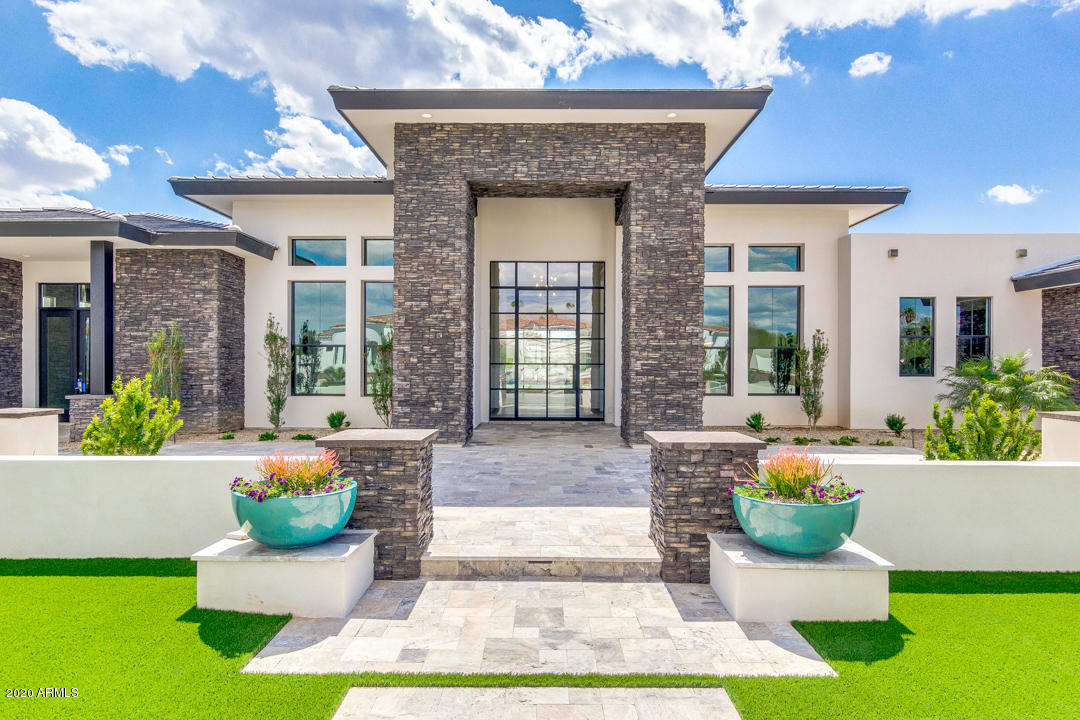 Stunning Forte Homes new build on over an acre in  beautiful Paradise Valley. This home is truly a masterpiece with 6974 sq feet of lavish finishes. Towering ceilings of 18 feet in the great room as well as 20 feet patio ceilings really maximize space. This 5 bed 5.5 bath also includes an office & movie theater/game room with all Dolby Atmos surround sound & 4K HD. Beautiful heated pool & spa as well. This home includes all Subzero/WOLF appliances in an amazing entertainer's kitchen. A 5 Car garage with a private motor-court & automatic gate is just another luxury included with this home.