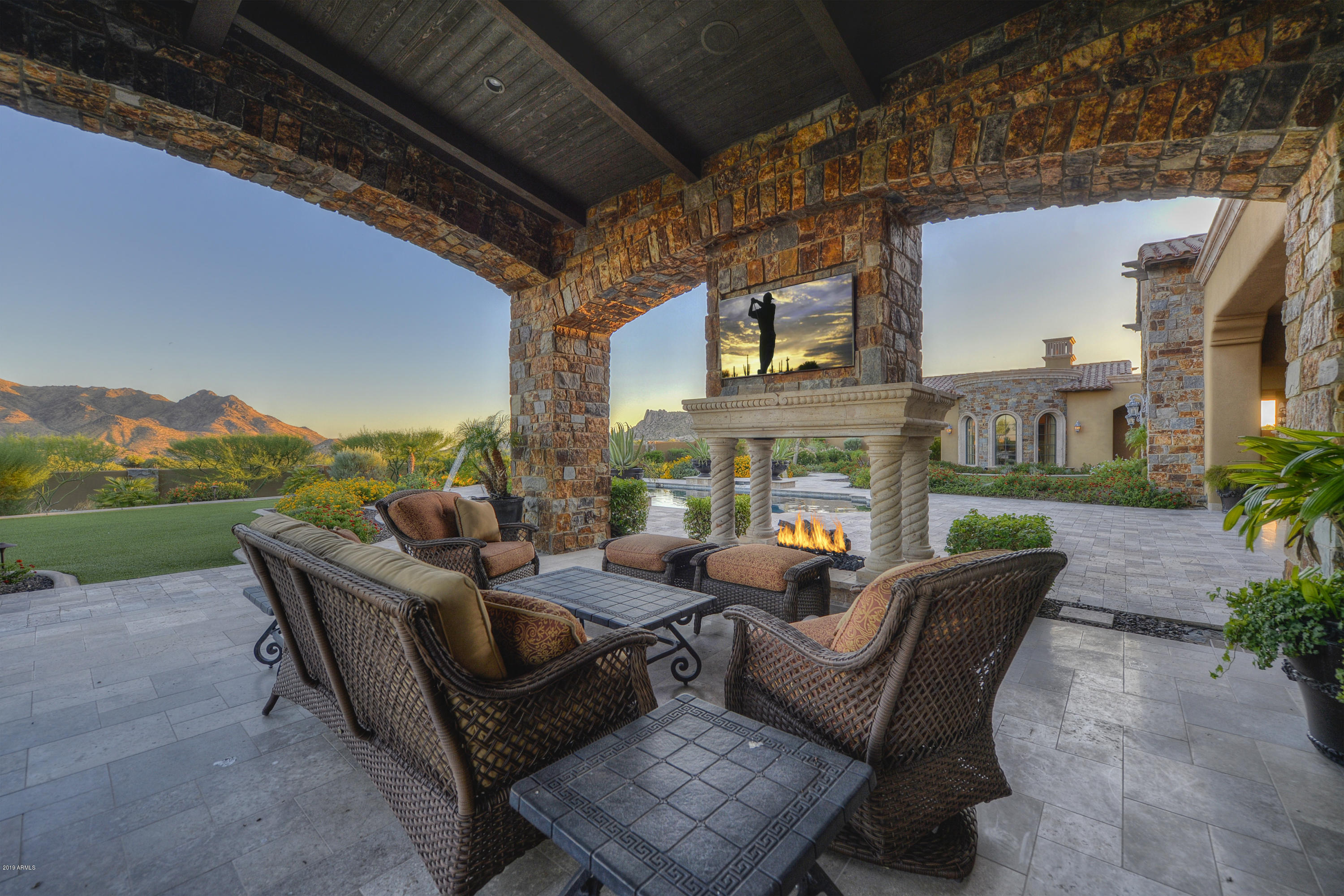 Inspired by generations of European country estates that echo a romantic lifestyle through classic architecture, this home on 2.54 acres in the unique and exclusive Cantabrica Estates, depicts a timelessness in character and design.  An open and flowing floor plan, spacious rooms, the most current technology and appliances and an outdoor lifestyle area that blends the indoor and outdoor areas seamlessly, this is a home that is perfect for any multi-generational family needs, or the corporate executive looking for a retreat.  It readily accommodates family activities and entertaining on any scale. 

As you arrive through the private, gated drive leading to the home, immediately, there is a sense of having entered an Italian Palazzo in one of the Italian country sides. Along with the classically finished, quality craftsmanship and simple elegance of this home, the 8257 square foot main house with its 6 garages and the 763 square foot detached guest house capture views of the delicately painted southwest Sonoran Desert and its magnificent surrounding mountain views at every turn.  
Highlighted are architecturally inspired ceiling treatments that include bricked domed, groined vault and hand-hewn cross beams, travertine stone flooring, Cantera stone fireplaces and pillars, venetian plaster and custom light fixtures, including imported jewel like chandeliers. 

Perfect for any chef is the kitchen, outfitted with a Wolf 8-burner hooded gas range, commercial sized side by side Subzero freezer and refrigerator, an island with prep space, farm sink, breakfast bar and a walk-in pantry. 
 
The common spaces include the family room, flowing into the kitchen and casual dining areas, a theater room and the very spacious great room highlighted with the rotunda shaped formal dining area, wine room, a full sized bar and a wall of mechanical pocketing doors that frame views of the mountains, pool and lush garden--blending the indoor and outdoor lifestyle areas seamlessly.

A large master suite with its massive Cantera stone fireplace, a comfortable seating area, large dual closets and a luxuriously appointed, resort style bath create an ideal and relaxing area to retreat at the end of the day.  Close by is the executive office or library.

Three extremely spacious, ensuite guest bedrooms in the main house offer travertine in the bath areas, large walk-in closets and access to patios. 

The separate guest house can double as a pool house.  It is finished in the same manner as the main house and offers its own kitchenette, full bath, walk-in closet and sleeping area. 

As a personal retreat, or for entertaining, the outdoor areas of this very distinctive home offers an inspired living space. Designed with a south facing yard that is easily enjoyed year-round, the ramada style covered patio boasts hand hewn plank beams, travertine stone flooring, and an open style fireplace with exposure on all 4 sides. The travertine patio expands from this area to surround the heated pool and spa, both with water features, with the yard continuing to a grass lawn appointed with garden-like landscaping.

Looking beyond this incredible home with its many unique and quality driven details, you will see what makes it and Cantabrica Estates so special--the endless and pristine beauty of the area showcased by the McDowell and Mazatzal Mountain ranges, Troon Mountain, Pinnacle Peak and Sonoran Desert views.
  
While just a short distance from all the city has to offer, Cantabrica Estates is about tranquility and open space.  For outdoor activities, close by are miles and miles of scenic hiking, biking and horseback riding trails, lakes for boating and fishing, as well as many world class golf courses.

Looking for more?  Scottsdale is known for its art and culture and offers an incredible mix of museums, shopping, restaurants, galleries and nightlife, along with a wide range of performing arts and special events such as baseball's spring training, Barrett-Jackson car auction, the Arabian horse show and the Waste Management Phoenix Open Golf Tournament.

Click on "Documents" tab for additional information about this home.