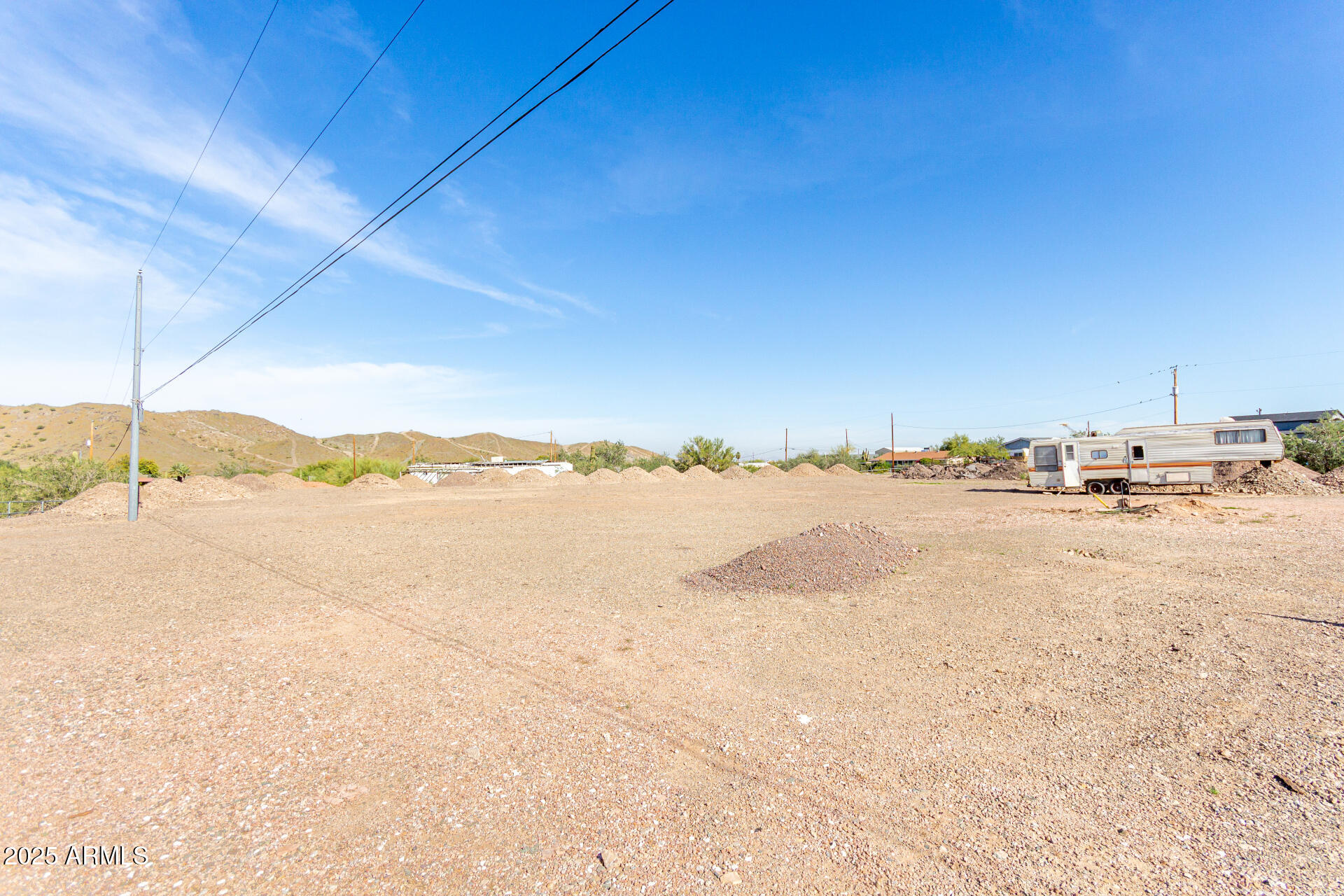 Build the life you've always imagined on this remarkable 1-acre parcel! With highly desirable R-43 zoning, it is perfect for those seeking space, privacy, and the freedom to design a true custom estate. This flat, usable lot offers ample room for your dream home, guest casita, RV garage, or equestrian setup, making it ideal for horse lovers and outdoor enthusiasts alike. Imagine waking up to the serene beauty of wide-open skies and ending your days with breathtaking mountain views that paint the horizon in vibrant desert hues! imagine a modern desert retreat or a charming ranch-style home, this property offers the perfect blend of versatility, serenity, and easy access to nearby conveniences.
The water service is shared with the neighboring property on the south side of the lot