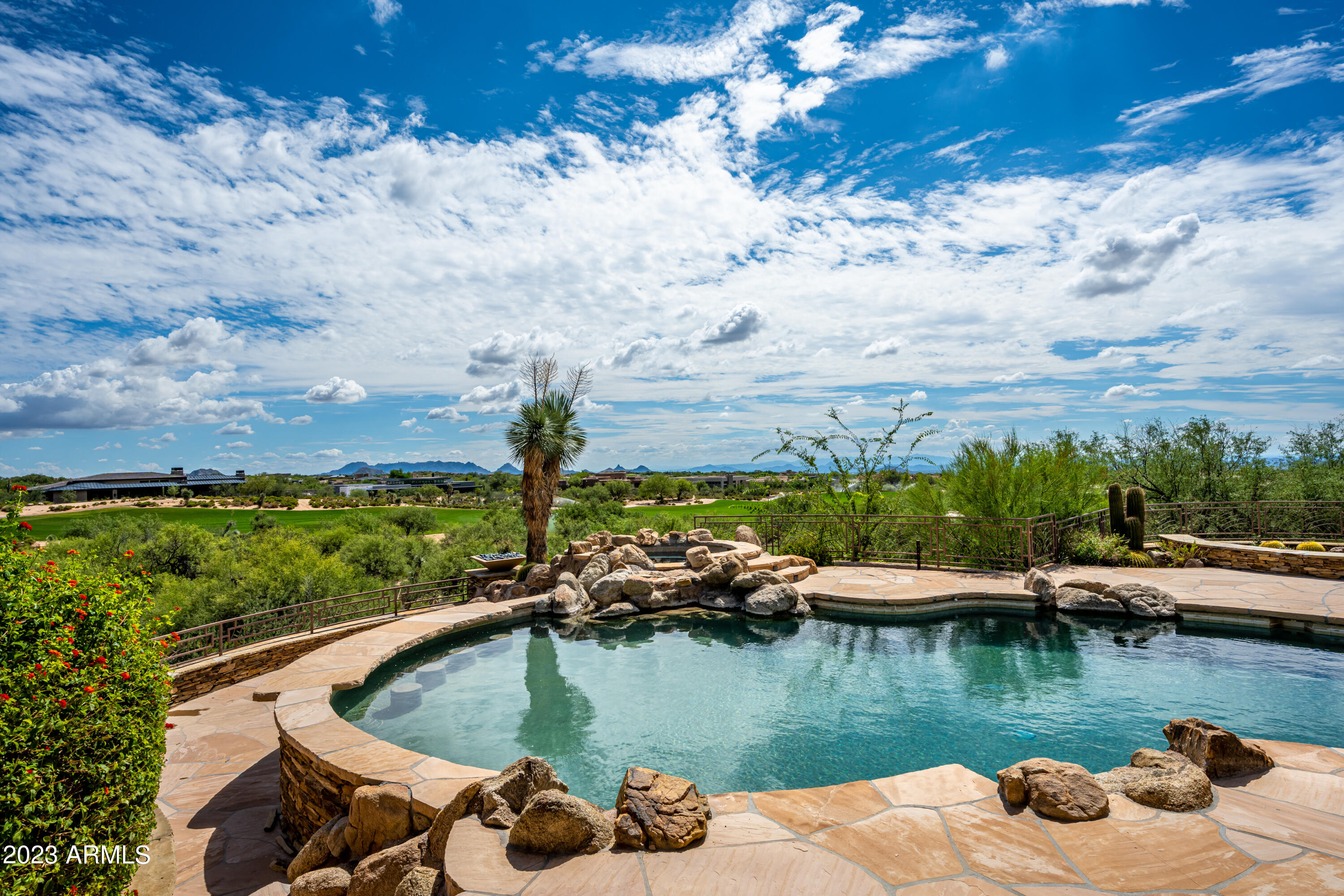**Golf Membership Available** Perched high above the 16th hole of the Apache Course in the Village of Apache Peak you will discover this superlative property that has been creatively reimagined and redesigned by international architectural interior designer, Jaque Bethke.  This private and serene setting has breathtaking views of the golf course, Pinnacle Peak, the McDowell Mountains, as well as spectacular sunrises and sunsets! This quintessential golf property will be esteemed by family and friends for years to come. A golf membership is available to transfer with the property at closing! This home is being sold turn-key, fully furnished including accessories and art work. Take immediate possession and start enjoying immediately. The spacious foyer greets you and leads to the great room containing a voluminous fireplace, which is open to the wet bar, formal dining/music room and kitchen area complete with Wolf appliances, a large island and an eat-in area.  A pass through to the expansive exterior patio and backyard area makes entertaining effortless with a complete outdoor kitchen, covered patio with a two way fireplace, and private spa & fireplace off the primary suite, along with the main pool and spa, and another seating area and fire feature. There is an expansive covered patio area for large gatherings!
The primary suite contains a lavish bathroom with breakfast bar, two commode rooms and a magnificent custom closet fitted with furniture grade cabinetry.  Step onto the patio and enjoy your private spa showcasing extraordinary views.  A spacious office is next door and could serve as an additional bedroom if needed.
On the opposite side of the house you will find a media room, ensuite bedroom and a great wine storage area and butler's pantry off the kitchen..
Take the elevator to the downstairs guest space with kitchenette, 3 generous ensuite bedrooms, living area, and an additional bath.   Each bedroom has an outdoor entrance that leads to the back area of the house to make a perfect retreat for family and friends. 
This downstairs space also contains a safe room! 
In addition there are 6 climate controlled garage spaces, owned solar panels, and a Control 4 smart home system. Additional car parking space can be added using a lift.  A walking trail is conveniently found at the base of the backyard.  With the availability of the golf membership enjoy all the amenities that Desert Mountain offers, including but not limited to, 7 golf courses, the award winning Sonoran fitness center and spa where you can also play tennis and pickleball, and hiking on the 20 miles of trails throughout the 8,300 acre community.  With the aid of advanced technology and top PGA and LPGA professionals The Jim Flick Performance Center will assist in improving all aspects of your game. There are 10 distinct clubhouses & grills for dining, and the new Renegade Clubhouse with a fresh contemporary ambiance which will be opening the end of 2023!
Please schedule a private showing to experience first hand the allure and uniqueness of this impressive property.