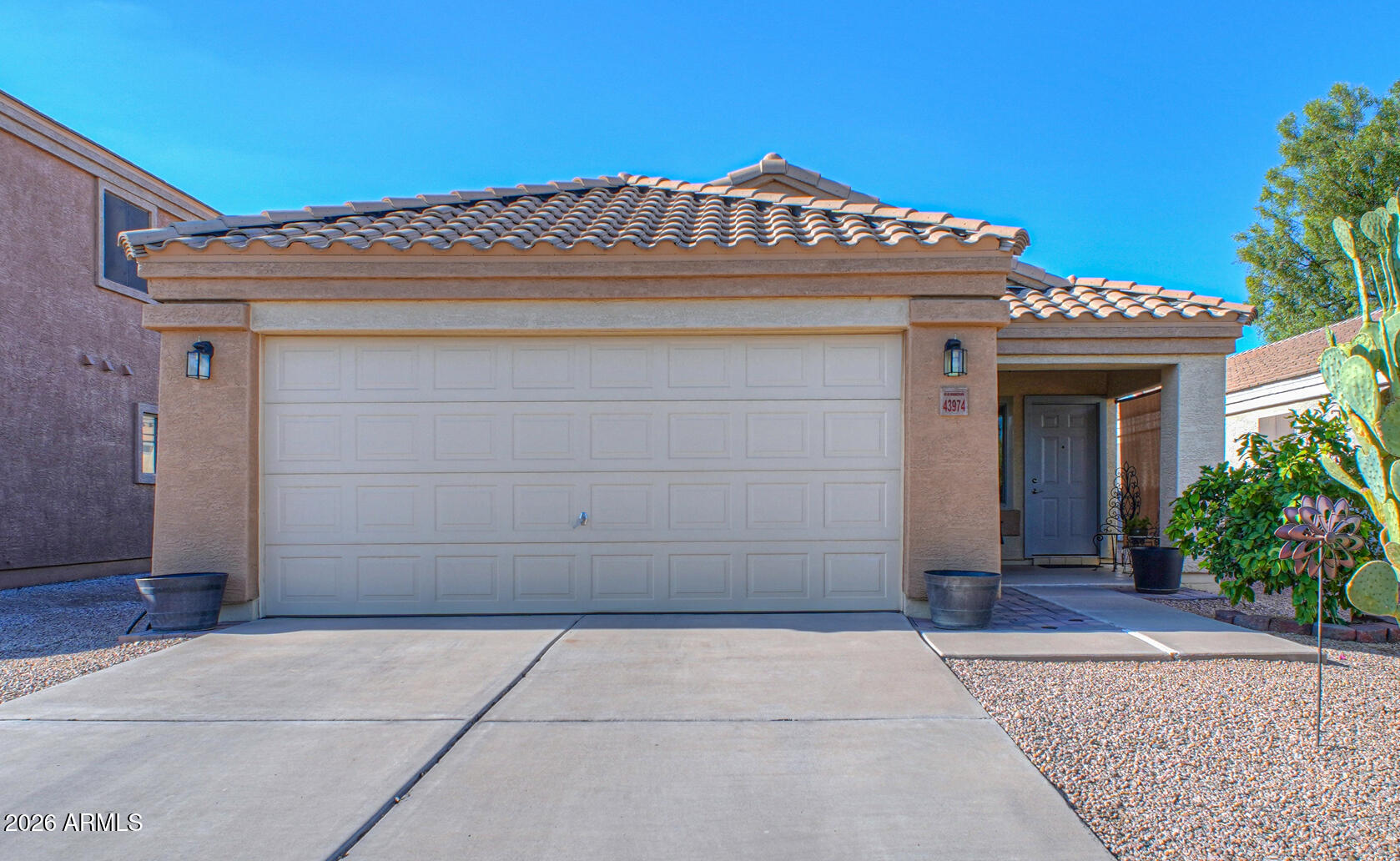 Meticulously maintained 3-bedroom, 2-bath home that's truly move-in ready! Featuring vaulted ceilings and an open floor plan, this home showcases pride of ownership throughout. Thoughtful updates include brand-new energy-efficient windows, a new sliding glass door, and a 1-year-old A/C unit for year-round comfort and energy savings. The inviting layout offers comfortable living spaces, while the covered front and back patios provide the perfect places to relax. The low-maintenance backyard features fruit trees, creating a peaceful outdoor retreat. Conveniently located near parks, schools, shopping, and dining, this home combines quality, comfort, and value. Don't miss the opportunity to own this beautifully cared-for home in Maricopa!