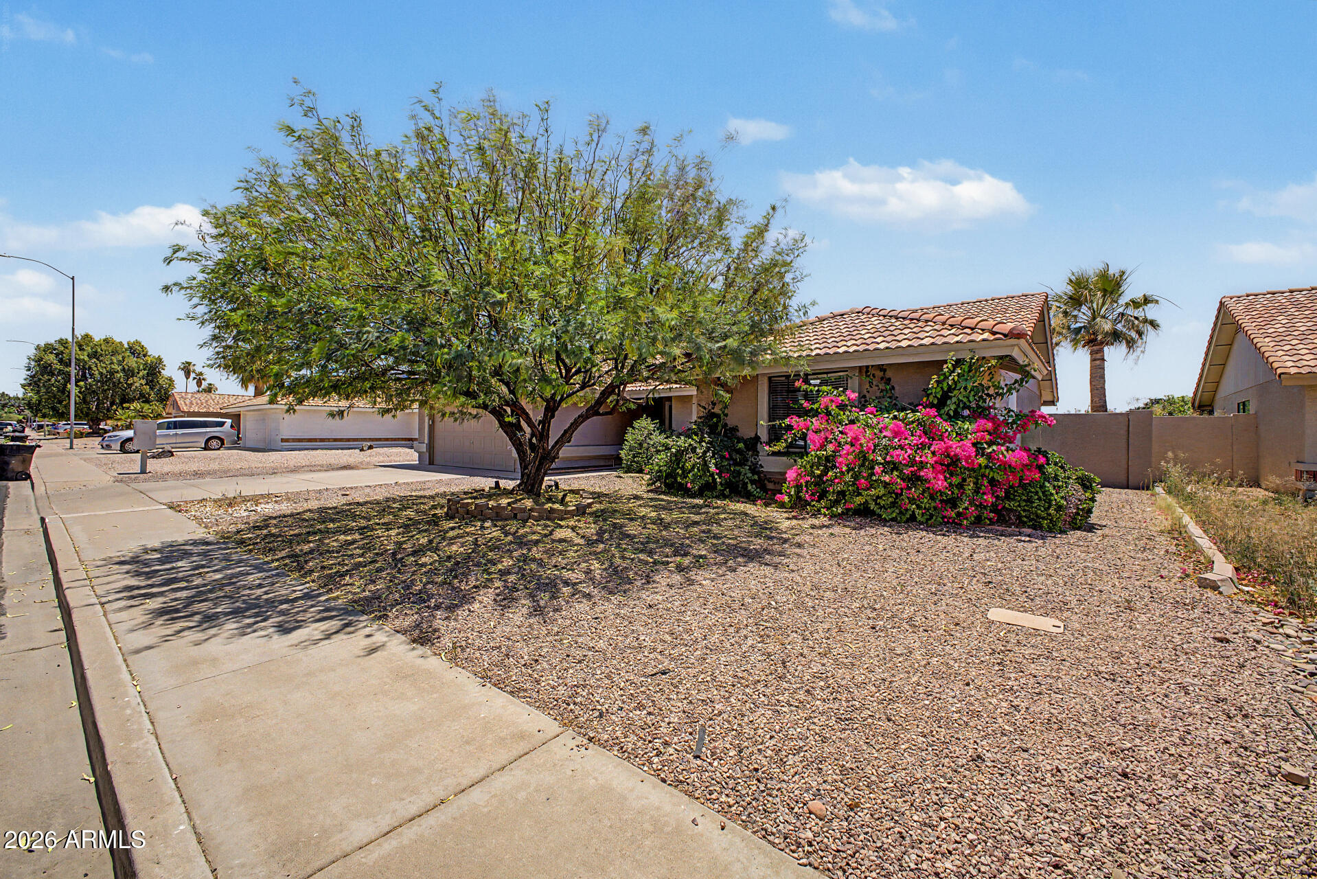4-bedroom, 2-bath single-story in East Mesa's Alta Mesa community on an 8,000+ sqft lot. Pool homes at this price point are increasingly rare in this zip code, and this one delivers: oversized pool, open pergola, and a large patio built for Arizona living. Inside, vaulted ceilings and an open layout connect the kitchen and family room with sightlines straight to the pool through a french door. Tile fireplace, bay window dining nook, breakfast bar, and stainless appliances. Primary suite has a full double-vanity bath with tub and shower. Guest bath fully renovated with quartz counters, white shaker vanity, matte black hardware, and frameless glass walk-in shower. Washer, dryer, and refrigerator all convey. Tile roof, low quarterly HOA, zoned for Red Mountain High School.