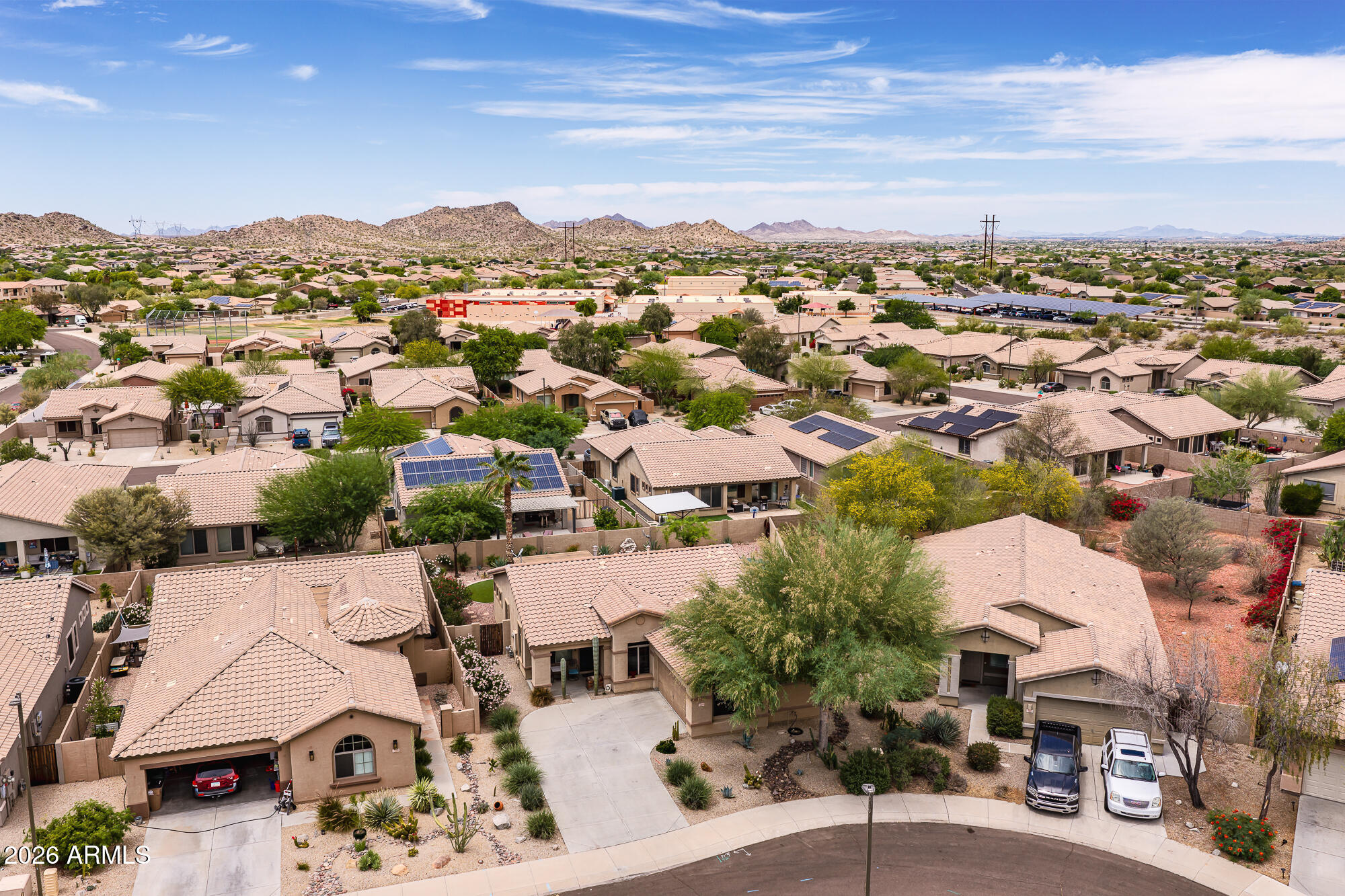 Welcome to this beautifully upgraded single-story home in highly sought-after Estrella Mountain Ranch! Featuring 2 bedrooms plus a den, 2 bathrooms, and situated on a spacious lot, this home offers the perfect blend of comfort, style, and Arizona outdoor living plus it may be  sold fully furnished. The backyard is an entertainer's dream with low-maintenance artificial turf, a putting green, cozy fire pit area, and an additional storage shed. Inside, you'll find custom touches throughout including tile flooring, stunning stonework accents, an upgraded fireplace, and a custom bar area in the dining space perfect for entertaining guests. The spacious primary suite features upgraded closet systems and a beautifully remodeled bathroom complete with a large custom tiled walk-in shower. The versatile den offers the perfect space for a home office, workout room, or guest area. This home can also be sold fully furnished, making it an incredible turnkey opportunity for full-time residents, winter visitors, or investors. Located in the award-winning Estrella Mountain Ranch community, residents enjoy access to incredible amenities including resort-style pools, fitness centers, scenic lakes, hiking and biking trails, fishing, and championship golf at the Jack Nicklaus-designed Golf Club of Estrella. The community also offers abundant HOA activities and events including concerts, holiday celebrations, fireworks shows, farmers markets, and more.