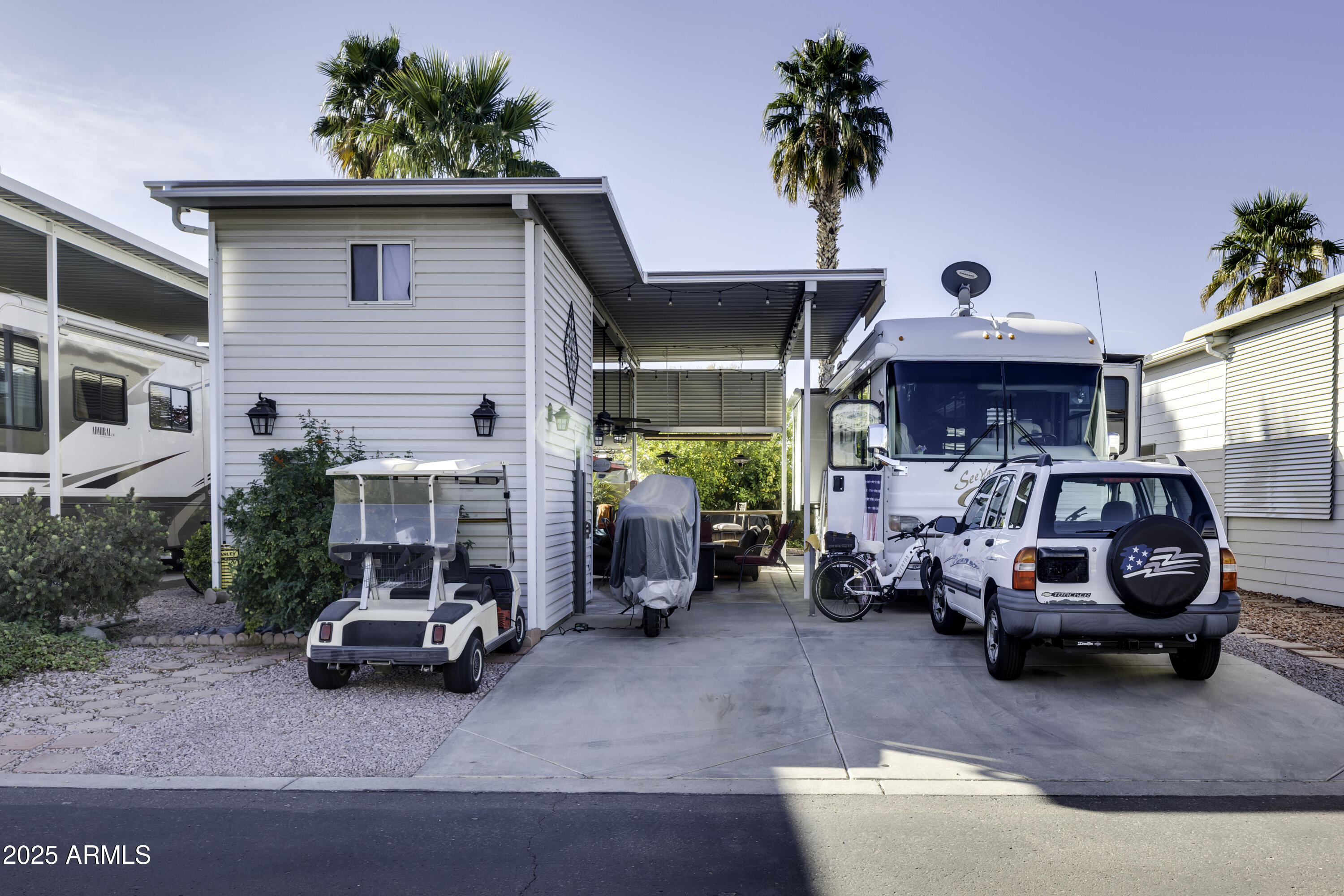 THIS RV LOT  IS THE JEWEL OF THE RESORT.  PRIVACY CREATED ON AN INTERIOR WALL.  A DESIGNER KITCHEN HAS BEAUTIFUL STAINLESS CABINETS, GREAT BUILT-IN BBQ AND COOKTOP, CLASSY TILE COUNTERS WITH BAR SEATING, SINK, DISPOSAL AND DISHWASHER. ENJOY THE TILED OUTDOOR PATIO AREA FOR ALL TO ENJOY WITH TWO FANS TO KEEP YOU COOL. PATIO AREA ALSO HAS AWNING DROP DOWN SCREENS FOR LOTS OF PRIVACY.  A TWO STORY SHED HAS STACKABLE W/D, REFRIGERATOR/FREEZER/ , LOTS OF CABINET SPACE AND AN ENCLOSED TOILET.  ROOM FOR ALL YOUR EXTRAS IN THE SECOND FLOOR.  AND DID I MENTION THERE IS A HOT TUB!!!!!! THIS PLACE HAS IT ALL.