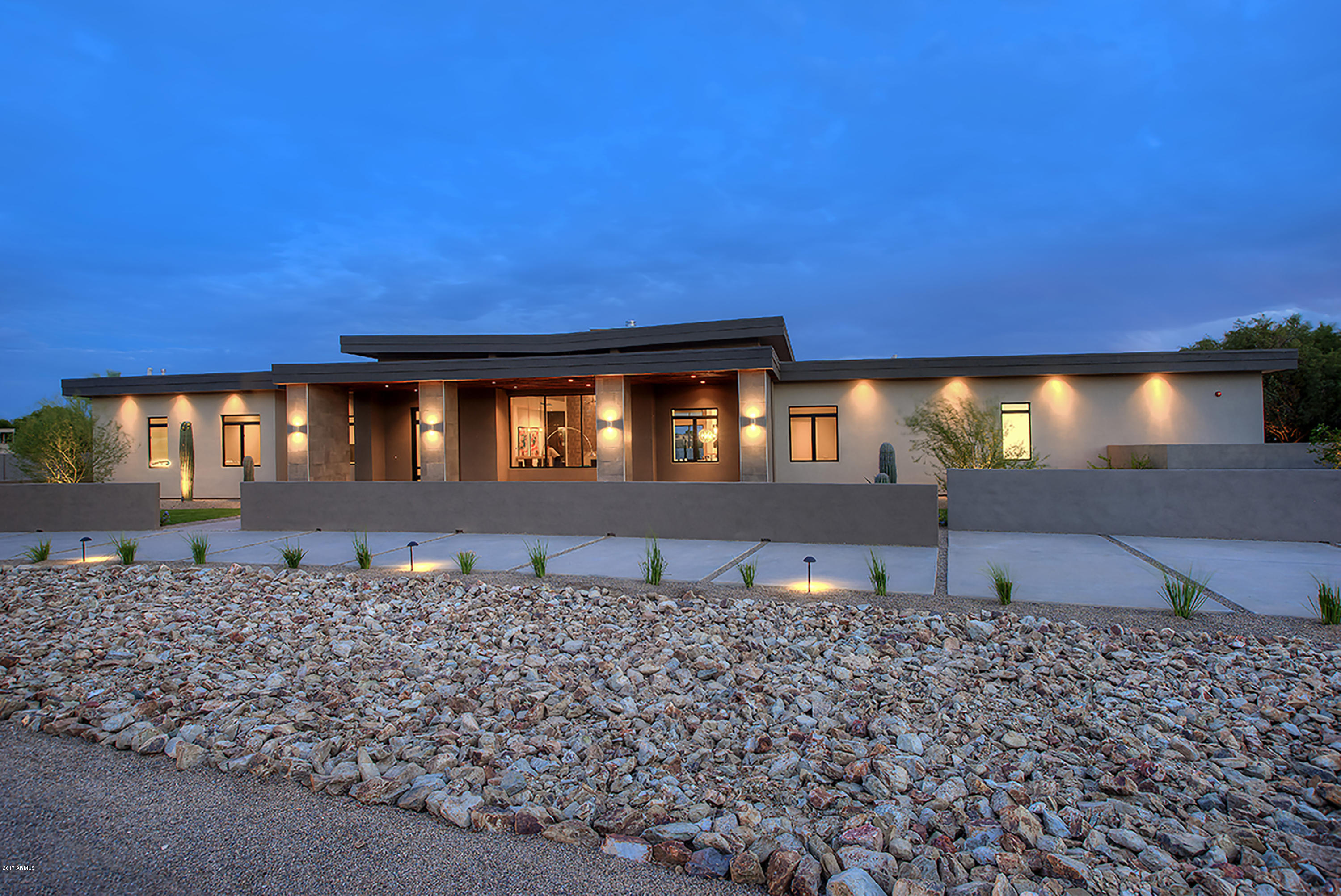 Absolutely positively the best buy in Paradise Valley on this modern style, jaw-dropping new built. Every element, finishes & materials, has been designed with extraordinary attention to details for privacy & comfort. The ultra-comfortable split-floorplan has 5 bedrooms, den/studio, bonus room & 6.5 baths. The luxurious master suite has a den/studio, huge closet & a sensational spa like bath. The kitchen sparkles with satin-finished counters, generous bank of cabinets, Thermador appliances, expansive multi-level counters & a huge pantry. Located on a prime acre with N/S exposure & it is beautifully landscaped with trees, shrubs, green grass, circular drive, private patios, gated courtyard, RV gate & spectacular backyard retreat with sparkling pool, swim-up bar & a raised negative edge spa.