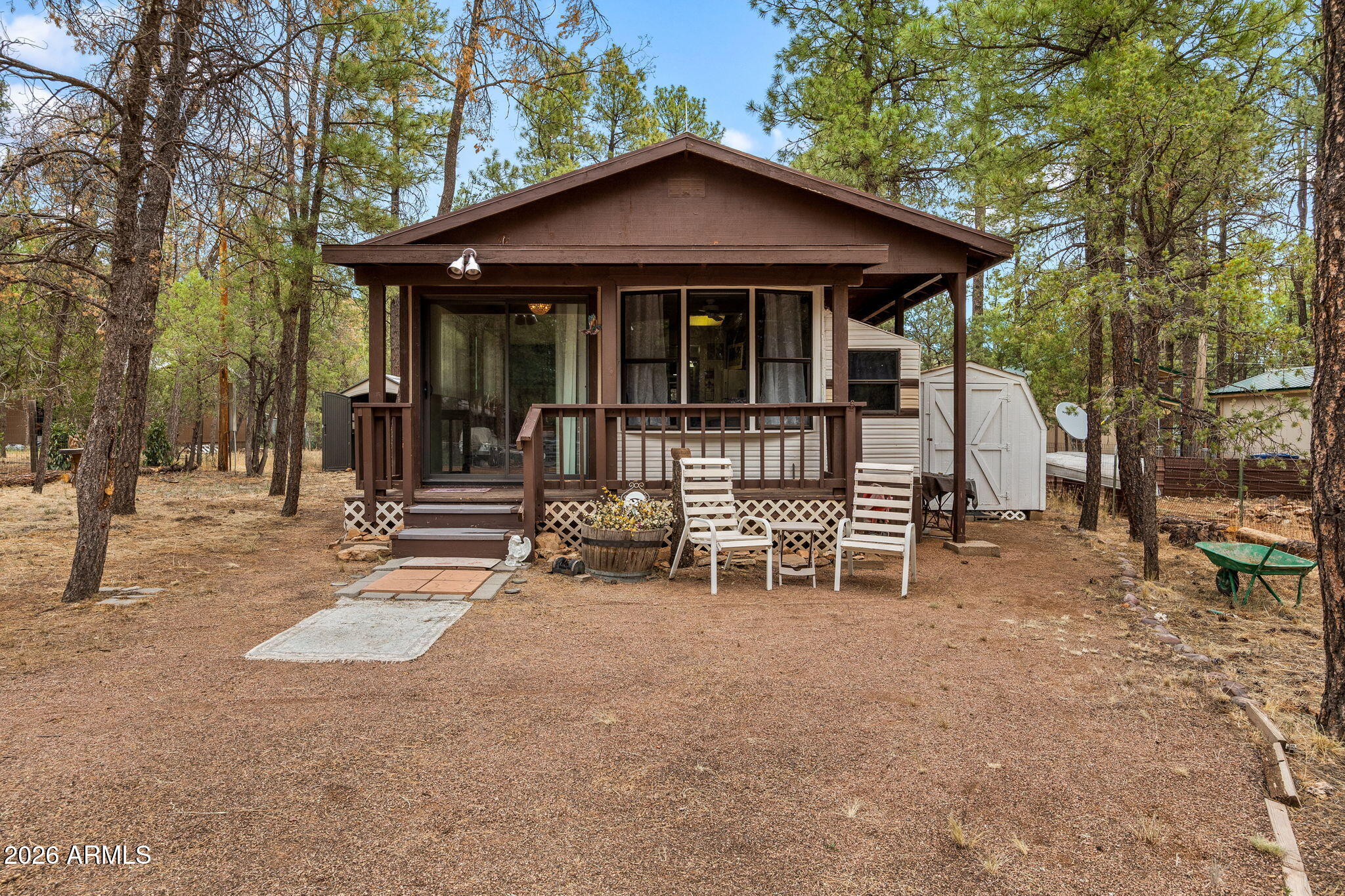 Turnkey cabin in the pines, furnished and ready for weekends up north. This 1 bed / 1 bath manufactured home sits on almost a quarter-acre double lot under tall ponderosa pines in Overgaard's Buckskin subdivision. A glassed-in sunroom opens to the covered deck, the perfect spot for morning coffee before heading out to the trails.
Furniture, washer, and dryer all convey, so you can bring a toothbrush and be moved in.The RV in back conveys as well. Storage shed, RV hookup, and RV parking for the toys.

With plenty of room to spread out, it's a great spot to make family memories in the mountains.

Minutes from the Apache-Sitgreaves National Forest, with hiking, ATV trails, and fishing lakes a short drive away.
