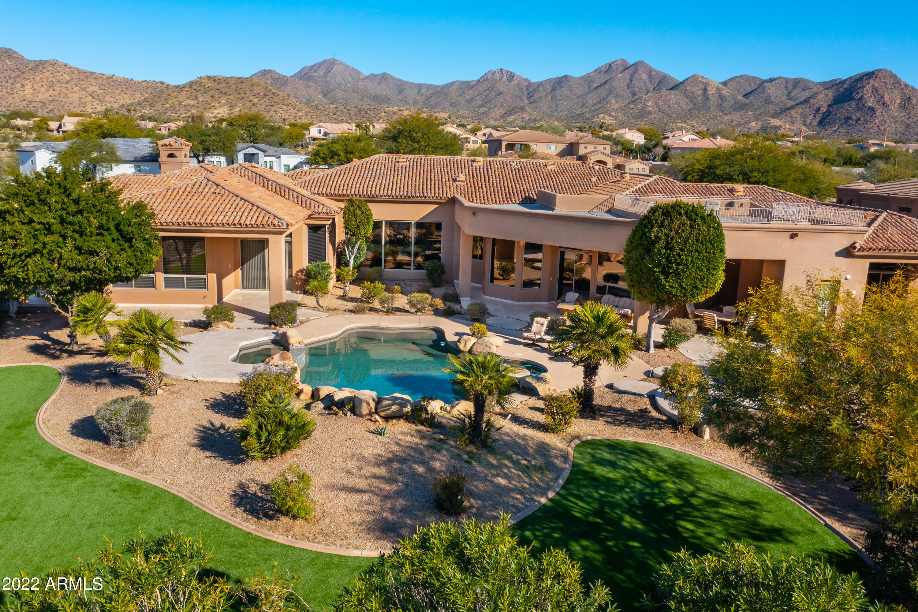 Located in the desirable McDowell Acres neighborhood on a private cul-de-sac, this custom built Tuscan contemporary home is spread over 5,720 square feet and features 6 oversized bedrooms and 5 full and 2 half baths, with plenty of space throughout. This home is has a large master suite with a sitting area that has a 2 way fireplace, fitness room, and a spacious master bathroom.  The living room, kitchen and family room all overlook the spectacular backyard which features a large pool and spa with water feature, fireplace, outdoor bbq, two newly turfed areas and ample space for entertaining. A roof top viewing deck offers panoramic views of the valley, Camelback Mountain, and the McDowell Mountains. The home is in process of being remodeled. The home is in process of being remodeled and there will be new wood floors throughout, newly painted cabinets, freshly painted interior, led interior lighting, quartz countertops & more.