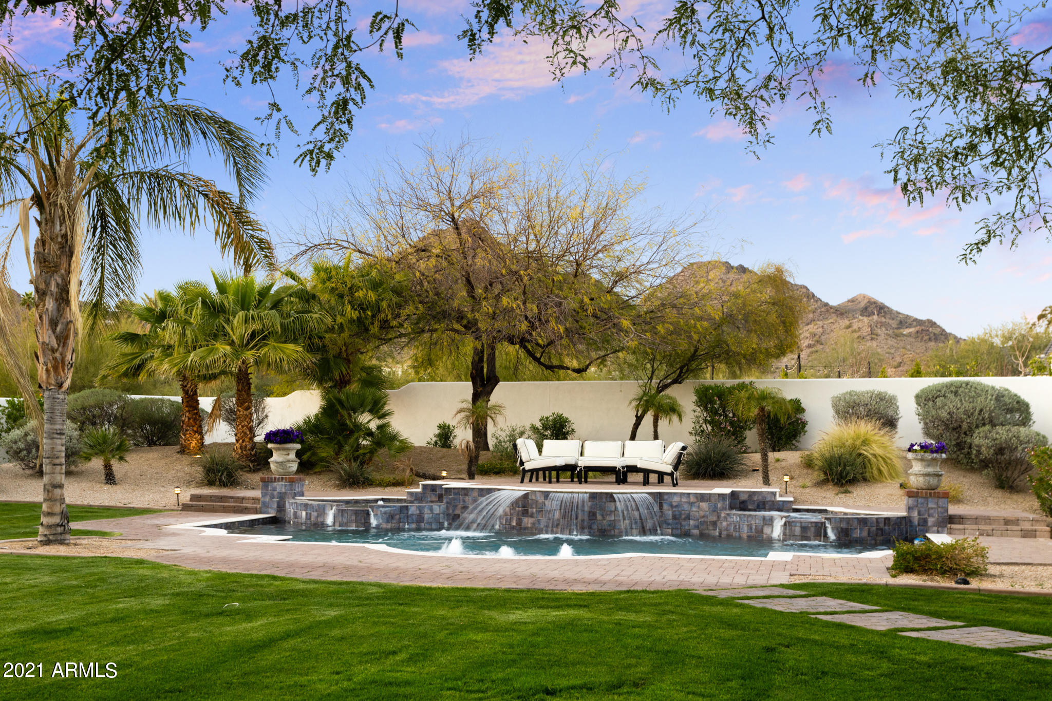 Look no further than this striking Mediterranean inspired estate! With timeless design, exquisite detailing and picturesque mountain views, this home will captivate you from the moment you walk in. Privately gated Santorini estate on 1.4 acres featuring 7 bedrooms (including guest house) 8.5 bathrooms, 6 car garage, movie theatre, office, game room and so much more. Beautiful entertaining space with eat-in gourmet kitchen and generously sized family room which opens to wet bar and temperature controlled 600 bottle wine room. Luxurious master suite with Cantarra stone accented fireplace, two huge clothing closets, steam shower and private courtyard. The detached guest house feature 2 bedrooms, 2 bathrooms, living space, full kitchen and laundry. Expansive resort style grounds including spacious covered patio, sparkling pool with water features and spa, lush green lawn and mature trees. This stunning home is ideally located just minutes from Phoenix Country Day School and your favorite hiking trails.  Schedule your private showing today before this beauty is gone.