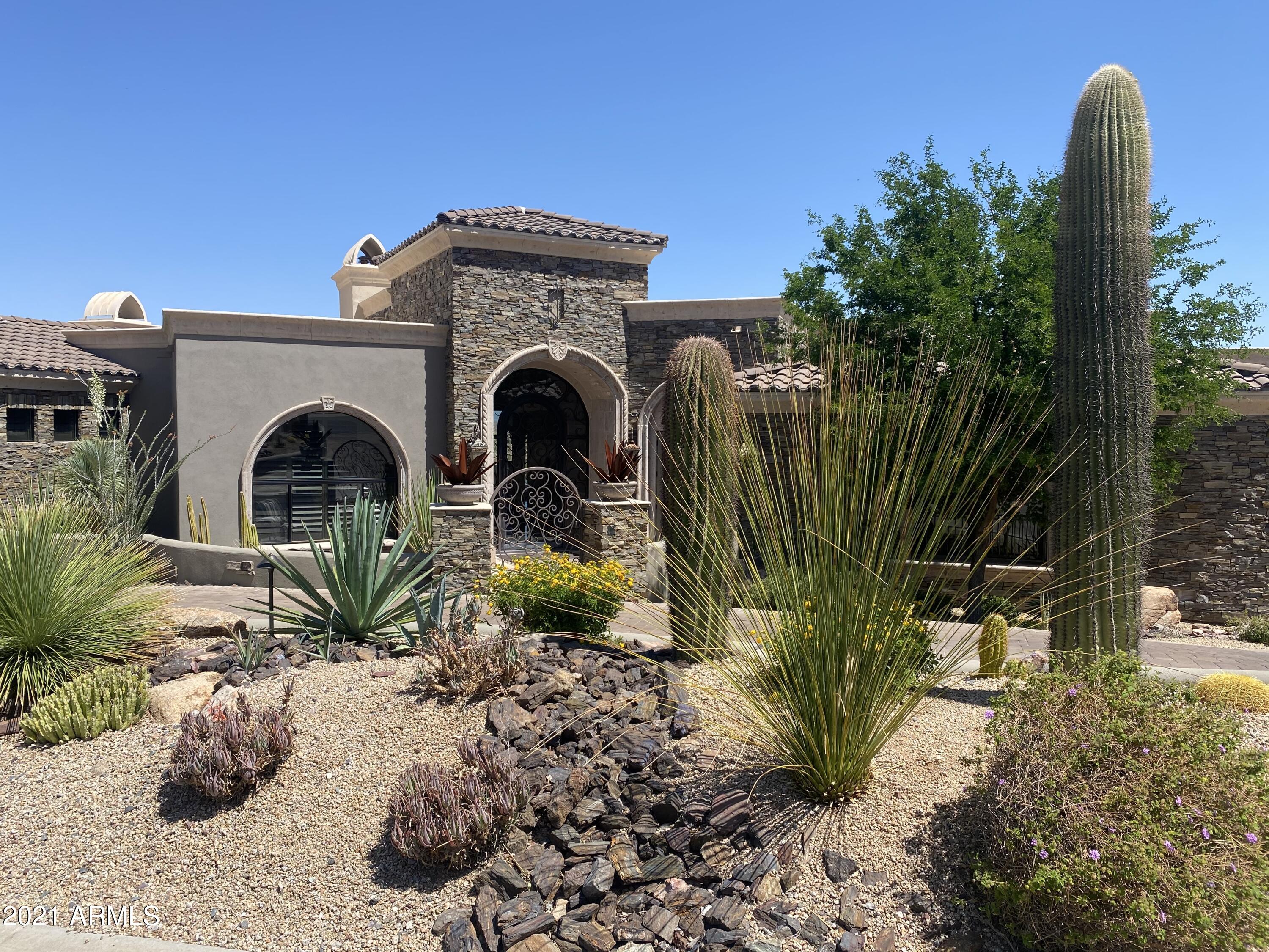 Unbelievable breathtaking VIEWS of mountains sunset & boulder outcroppings showcase this like new home.  The split floor plan includes 4 bedrooms, including a swank Casita, office and a home theater - all on ONE LEVEL. The Viking kitchen boasts 2 dishwashers/dbl. ovens/warming drawer/48'' cook-top w/cantera hood, a 72'' fridge/freeze, custom pantry & wet bar surrounding an enormous 8x10' island.  Other features include floor to ceiling 10' high butt glass walls, auto telescoping door, arched windows, cantera fireplaces wet bar & 100-bottle wine closet, coffered/groined/hand painted & box beamed ceilings,  custom cabinetry, infinity pool & spa, 2100/sf covered patio.complete w/outdoor kitchen & fire pit & fire features, misters & upper view deck, gated courtyard entrance w/fountain, Not to be overlooked are the security system w/cameras, central vac, whole house speakers and 9-Seer 4-zone air conditioners. This home brings AZ living at its best and if VIEWS are on your clients wish list you have found it!