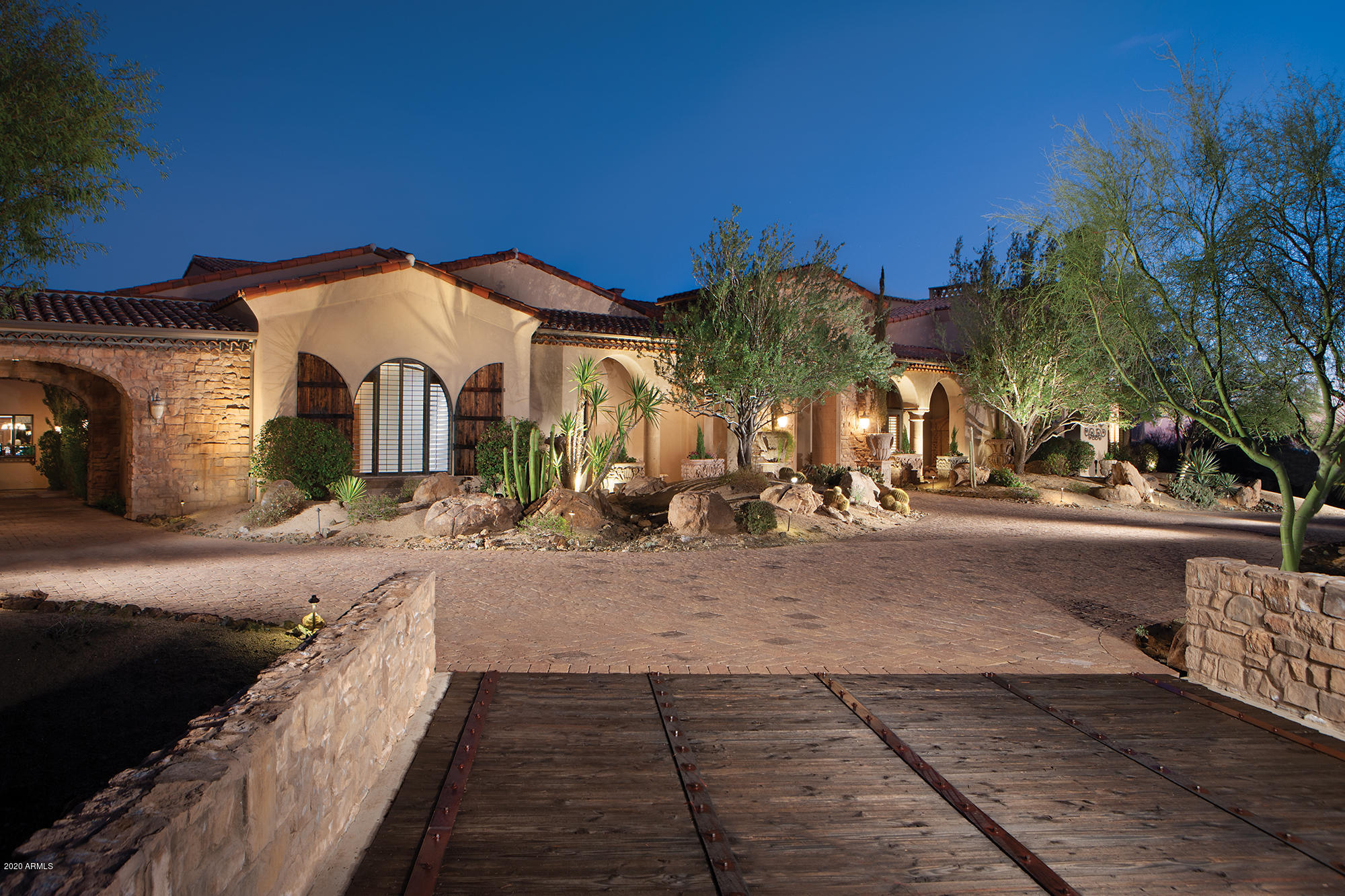 This European style estate rests on 3.5 private acres and is full of extravagant features and finishes. They include your entrance through iron gates and wooden bridges and then, into a completely enclosed atrium. Inside you'll find magnificent groin vaulted ceilings, murals, beamed ceilings, stone and wood floor, French doors and feel of a true European renaissance home. Pinnacle Peak views are featured from the verandas and around the pool. A master suite with masonry fireplace, a romantic bath and adjoining exercise and steam rooms. Also included is an executive office, theater, gourmet kitchen, putting green, guest house, 1300 bottle wine cellar, pool spa a 12 car garage and a huge man cave/media/game/auto show room.