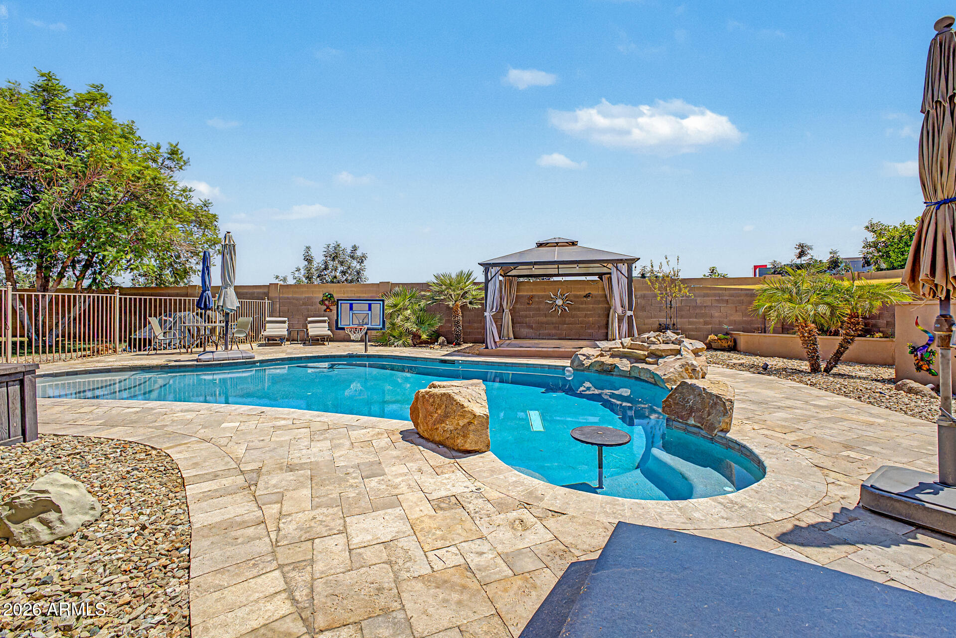 Hard to find a HUGE 16,254 sq ft cul-de-sac lot home with pool, covered patios, grass and mature trees and RV gate in the city!  This home is in the desirable Highlands at Arrowhead Ranch. The home is 2,594 square feet, 4-bedroom, 2-bath, Den and provides a comfortable layout with generous living spaces throughout. Formal living and dining areas greet you upon entry, while the open eat-in kitchen with center island flows into the family room, perfect for everyday living and entertaining. The home also features a fireplace, beautiful tile throughout, and a spacious primary suite with a large walk-in closet, renovated bathroom w/walk in shower and additional storage. Conveniently located near shopping, dining, schools, parks, and Loop 101 access
