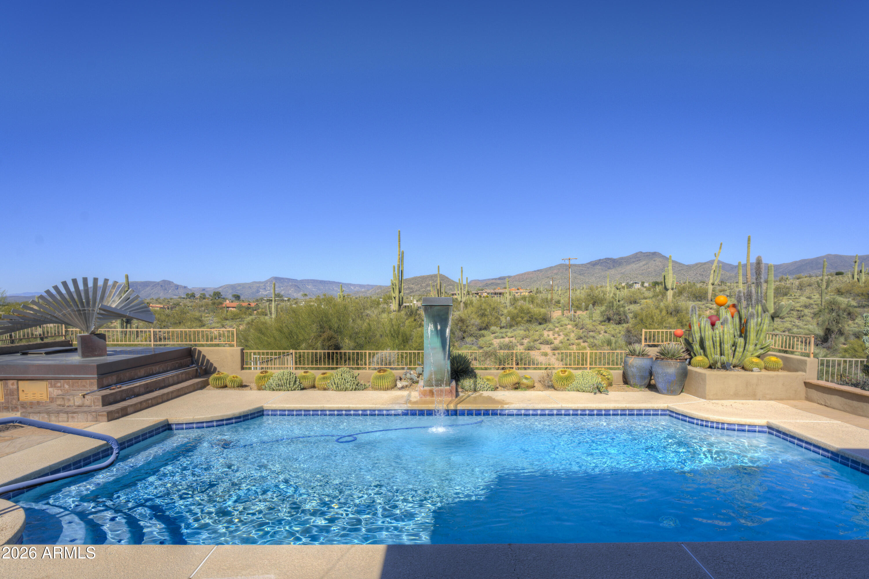 Located in the picturesque, rolling hills of Carefree is a treasure of a home extensively renovated in 2005 with views that are unparalleled.  Greeted by a charming paved front patio and whimsical, artistic gates, you enter through the foyer and are taken away by uninterrupted mountain views that are grand and sweeping.  Fabulous open floorplan lends itself to entertaining. Eat in chef's kitchen with oversized island and an abundance of custom cabinetry, walk in pantry.  Floorplan is thoughtful, with a primary suite that offers private den / office space.  Backyard is rich in specimen quality native desert plants and a refreshing pool.  Oversized patios offer opportunities to dine al fresco. Continued below Set just apart from the main home, an artist's casita offers a private, inspiring retreat. Bathed in natural light and surrounded by desert flora, it's ideal as a studio, guest space, or quiet sanctuary for creative work. Together, the home and casita create a peaceful compound, perfect for those seeking solitude, inspiration, and the timeless beauty of the desert landscape.