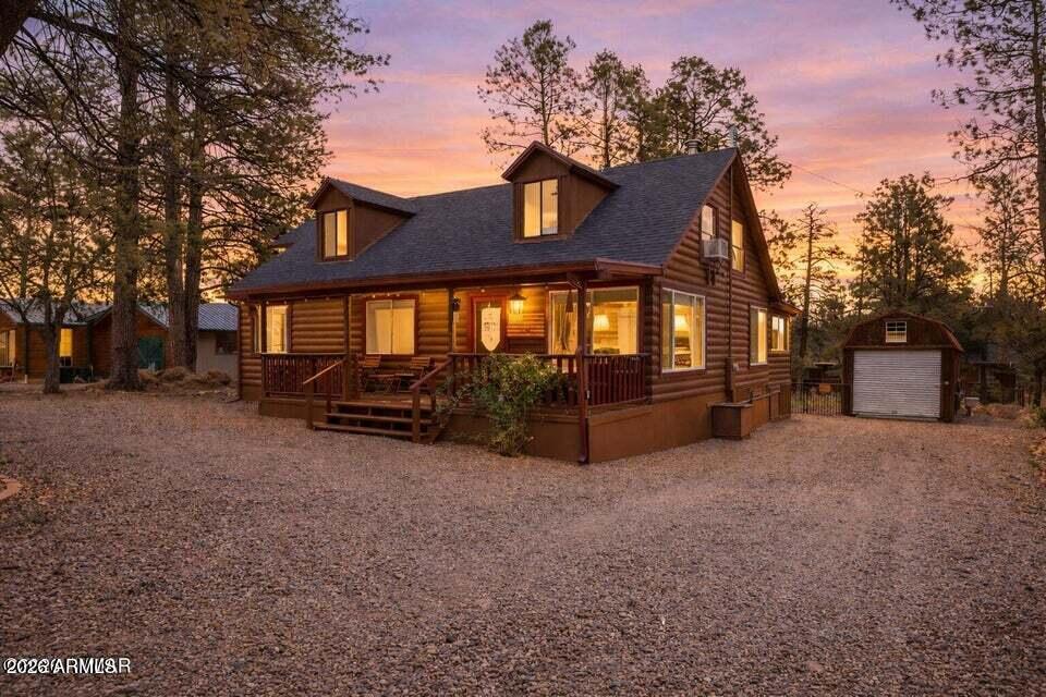 Offering approximately 1,112 sq ft on the main level plus an additional 847 sq ft of living space upstairs, this beautifully updated log sided home has been completely transformed and offers incredible flexibility for the whole family. With generous living space and multiple bonus areas, it easily functions as more than just a 3 bedroom home, offering plenty of room for guests, hobbies, or even separate living quarters.
The main level features 3 bedrooms and 2 bathrooms, along with a dedicated laundry room with the dryer included for added convenience. A custom spiral staircase leads upstairs to three additional rooms, a bathroom, and charming dormer windows that bring in natural light and character. With the right layout, this home has the potential to function as a 5 bedroom. Inside, yo will find warm oak cabinetry, wood accents, and beadboard details that create a cozy farmhouse feel throughout.
Step outside and enjoy multiple outdoor living spaces, including a spacious covered front deck with a sliding gate, perfect for kids or pets, a screened in porch for year round enjoyment, and an additional open back deck ideal for soaking up the sun.
The property also features two versatile outbuildings. One is insulated with power, a roll up door, and a metal roof, ideal for a workshop, storage, or recreational use. The second structure, also equipped with power, offers a great space for a craft room, studio, or gardening setup. Previously used as a short term rental, this home is an excellent opportunity as a full time residence, second home, or investment property. Whether you're looking for a peaceful retreat in the pines, a place to gather with family and friends, or a property with strong income potential, this one checks all the boxes. Furnishings available on a separate bill of sale.