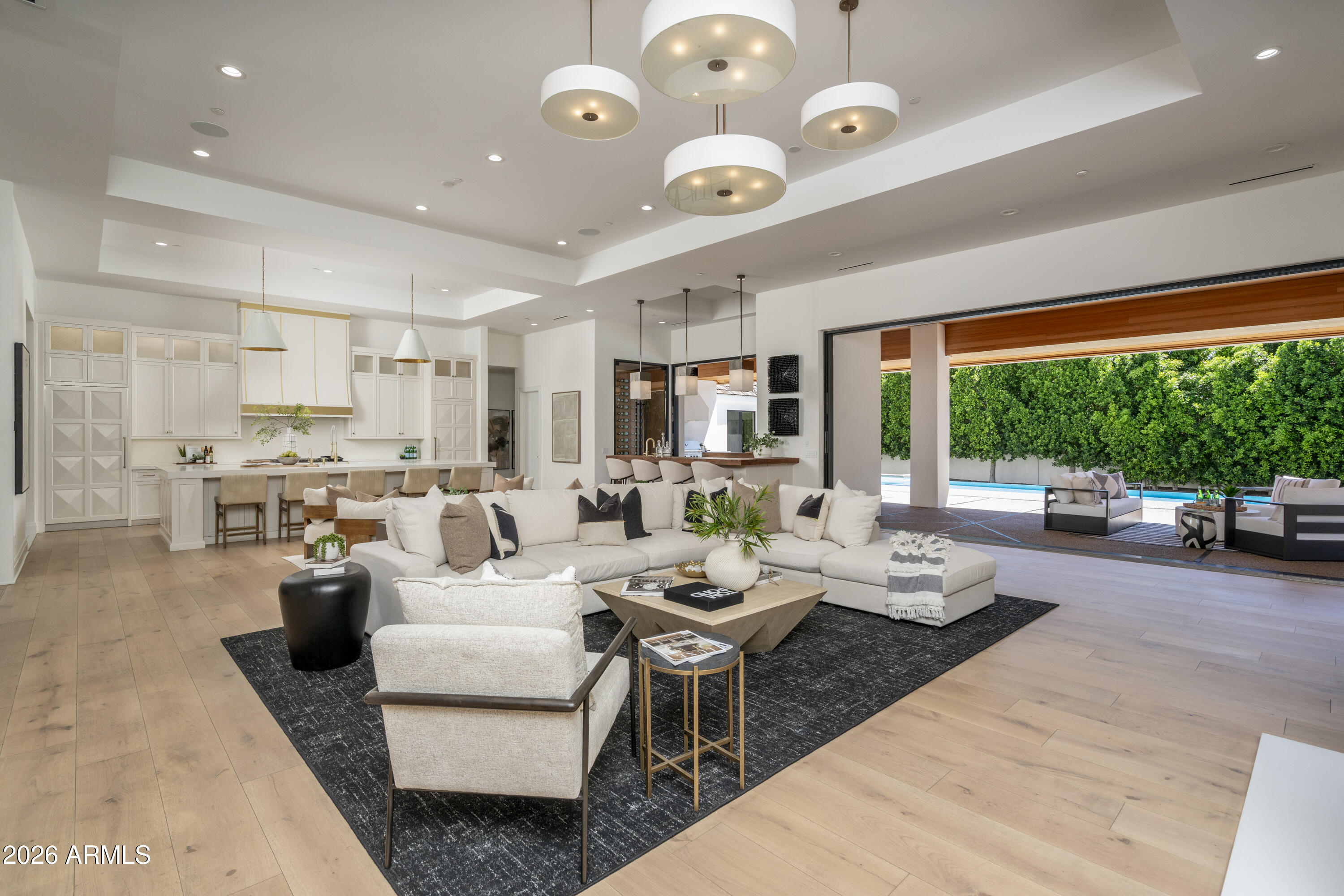 Situated on one of the most desired streets in all of AZ.  This extraordinary Gated Arcadia Estate on Exeter Boulevard offers an unmatched blend of luxury, privacy, design, & Camelback Mountain views.  Perfectly positioned in the heart of Arcadia, this resort-style masterpiece captures the essence of elevated AZ living with incredible Camelback mtn views, exceptional entertaining spaces, and seamless indoor-outdoor design.  Featuring 6 spacious bedrooms, 6.5 bathrooms, versatile flex room, and a private guest casita, all privatized behind the Gated Estate fence. Thoughtfully designed for both everyday comfort & unforgettable entertaining. Soaring 15-foot ceilings and expansive open-concept with huge chef's kitchen along with butler's pantry.  Two massive 10 ft tall pocket door systems completely transform the entertaining experience, one opening the great room to the expansive covered back patio & another creating a true indoor/outdoor bar experience, perfect for hosting year-round.  The backyard is nothing short of spectacular, highlighted by a stunning 50 ft negative edge lap lane pool & oversized spa seating 12+ guests. Enjoy the absolute privacy and tranquility of massive ficus tree hedge walls privatizing the perimeter of the back & side yards.  Cozy fireplaces accentuate both the front and rear outdoor living areas.  From the expansive front patio enjoy stunning Camelback Mountain views from behind the comfort of gated tree lined ultimate privacy.  The private primary retreat is truly in a class of its own. Designed as a secluded sanctuary, the expansive owner's suite features massive interior shower, spa like outdoor shower, oversized vanities, dual water closets, two secret doors, and luxurious finishes throughout creating a sense of intrigue rarely found in today's luxury homes. A secret passageway discreetly connects the suite to the great room, blending functionality with exceptional architectural detail.  Adding to the home's thoughtful design and privacy, another concealed hidden door leads to a secure safe room/panic room.  Car enthusiasts will appreciate the 4 car garage configuration, including a detached oversized garage with extra height designed to accommodate a car lift, allowing space for up to 5 vehicles.  A very rare opportunity to own one of Arcadia's most impressive properties on one of the finest sought-after streets in Arizona.  This is a true ultimate Arizona resort experience.