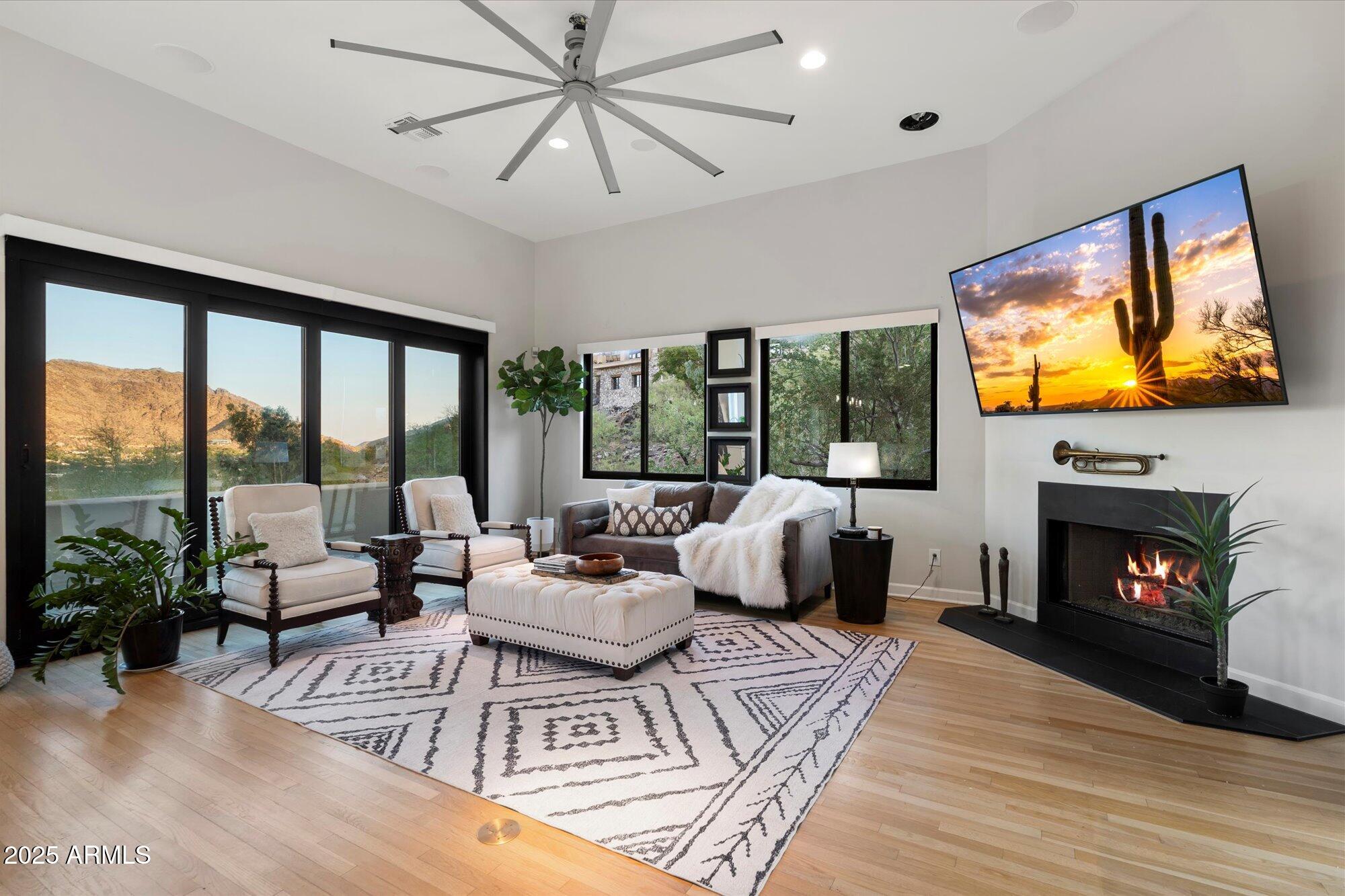 Nestled amidst the hillside within highly desired Tatum Canyon in Paradise Valley, this exquisite retreat boasts expansive views of Camelback Mountain, Mummy Mountain, the McDowells, Phoenix Mountain Preserve and City lights! Offering unmatched privacy, breathtaking sunsets and spectacular views from every single room overlooking the Valley! Upon entering, you are greeted by a grand foyer that leads into spacious and beautifully appointed living areas, media room, den, dining room, and contemporary gourmet kitchen featuring custom cabinetry with quartz countertops and massive waterfall island; each room capturing their own unique views. The upstairs primary suite is a sanctuary of tranquility, featuring a fireplace, private balcony, ensuite bath with a soaking tub, and yoga studio with expansive views that invite relaxation. 
Primary suite patio invites stunning city light views each evening!
Two additional bedrooms feature an ensuite bath and offer versatility for guests or home office. On the lower level you will find an extended length garage with built-in cabinetry and an attached temp controlled office/hobby room with additional storage space.
Outside offers the perfect setting for relaxing poolside, dining, entertaining guests, or simply soaking in the serenity of the surrounding landscape. A true entertainer's dream, with the perfect combination of indoor-outdoor living. 
No HOA! Located in one of Paradise Valley's most coveted neighborhoods, this home combines the privacy and tranquility of hillside living with convenient access to upscale shopping, dining, hiking, and golf. Whether you seek a peaceful refuge or a place to entertain in style, this exceptional residence offers a rare opportunity to experience the ultimate in AZ living.