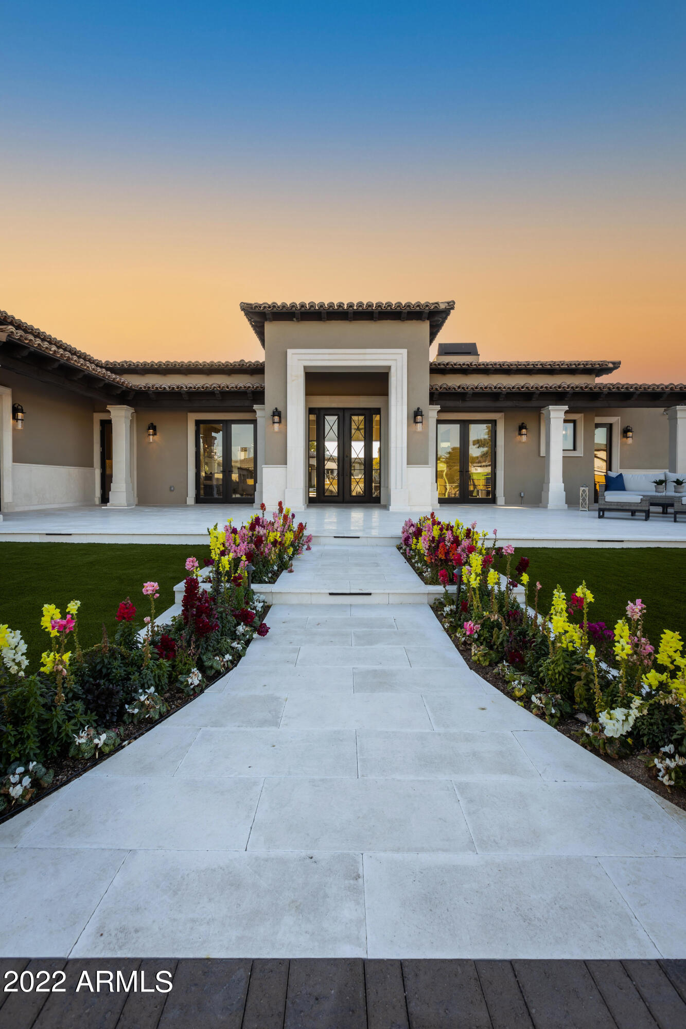Luxury Transitional Estate, recently completed New Build designed by Architect Domenic Berta, is located on a one-of-a-kind parcel in Cactus Acres. 1.21-acre lot nestled between two quiet cul-de-sacs. Secured behind dual, private gated entrances, this resort style home of 6,772 sq. ft. includes 5 bedrooms, 5.5 bathrooms, large Great Room, Game/Bonus room, distinguished Office, and Exercise/Bonus room attached to the Master Suite. This home also offers a 4-car garage and an oversized, air conditioned, pull-through, RV Garage.
A 2,450 sq. ft. detached Guest House, found just on the other end of the pool, includes full kitchen, 2 bedrooms, 2.5 bathrooms, Living Room with Fireplace, Laundry room, Office/Den, 2-car garage and RV gate. Dana Reynolds Interior Spaces, has designed a fresh and timeless aesthetic from the ground up. The open floor plan leads you directly into the Great Room with a custom stained, wood beam ceiling feature , 6-panel, retractable patio doors and fireplace. The room flows to the Dining area and Kitchen to provide ample entertaining space, stainless steel Wolf appliances, and quartz countertops. This expansive Kitchen offers a pristine quartz island with waterfall edge, limestone barrel ceiling, Butler's Pantry, Walk-Through Pantry, Banquette, and custom Wine Room. Provenza hardwood floors throughout the home and carefully selected, tile in bathrooms and laundry rooms. Each room in the home boasts unique tile choices from Facings of America. The Master Suite is located on it's own wing of the home behind double doors, containing a fireplace, built-in bar, and large enough area to sit and enjoy a view of the pool. His and Hers, substantially sized, closets featuring marble and quartz countertops, and a laundry pull-through to the Laundry room on the other side. Through another set of double doors lies the Master Bathroom with large soaking tub, steam shower, and his and hers separate vanities.
The opposite end of the home contains the Kid's bedrooms, secondary Laundry room, and Game/Bonus room. The hallway on this wing, features an art wall with built-in cabinetry and a splash of color. The Game/Bonus room contains a custom millwork wall and pre-wired for two TVs. Making your way back to the Great Room, you will find the Wine Room with custom glass and peg boards which holds 180 bottles. Opposite of the Wine Room is the Office with custom painted accent wall and ceiling. This room also offers a custom corner window which looks out at the beautiful McDowell Mountains. Making your way to the Powder Room, you will find the most elegant marble tile and countertop-to-ceiling mirror resting upon marble countertops. 
This home features a hand-carved limestone entry way, kitchen and hallway ceilings, and fireplaces. The patios are covered with Turkish limestone making it perfect to walk on come summer months. Custom spiral staircase will lead you to a covered observation deck where you can enjoy views of McDowell Mountains and Paradise Valley. Large, heated pool and spa at the center of entertainment between the Main House, Ramada, and Guest House. On the other side of the pool, you will find the ever-so-challenging, 6-hole, putting green. The exterior of this home is equipped with gorgeous landscape lighting to bring life to the night.
No expense was spared in the construction of this beautiful home. Tremendous pride was taken by the builders, in their product, and it shows.
