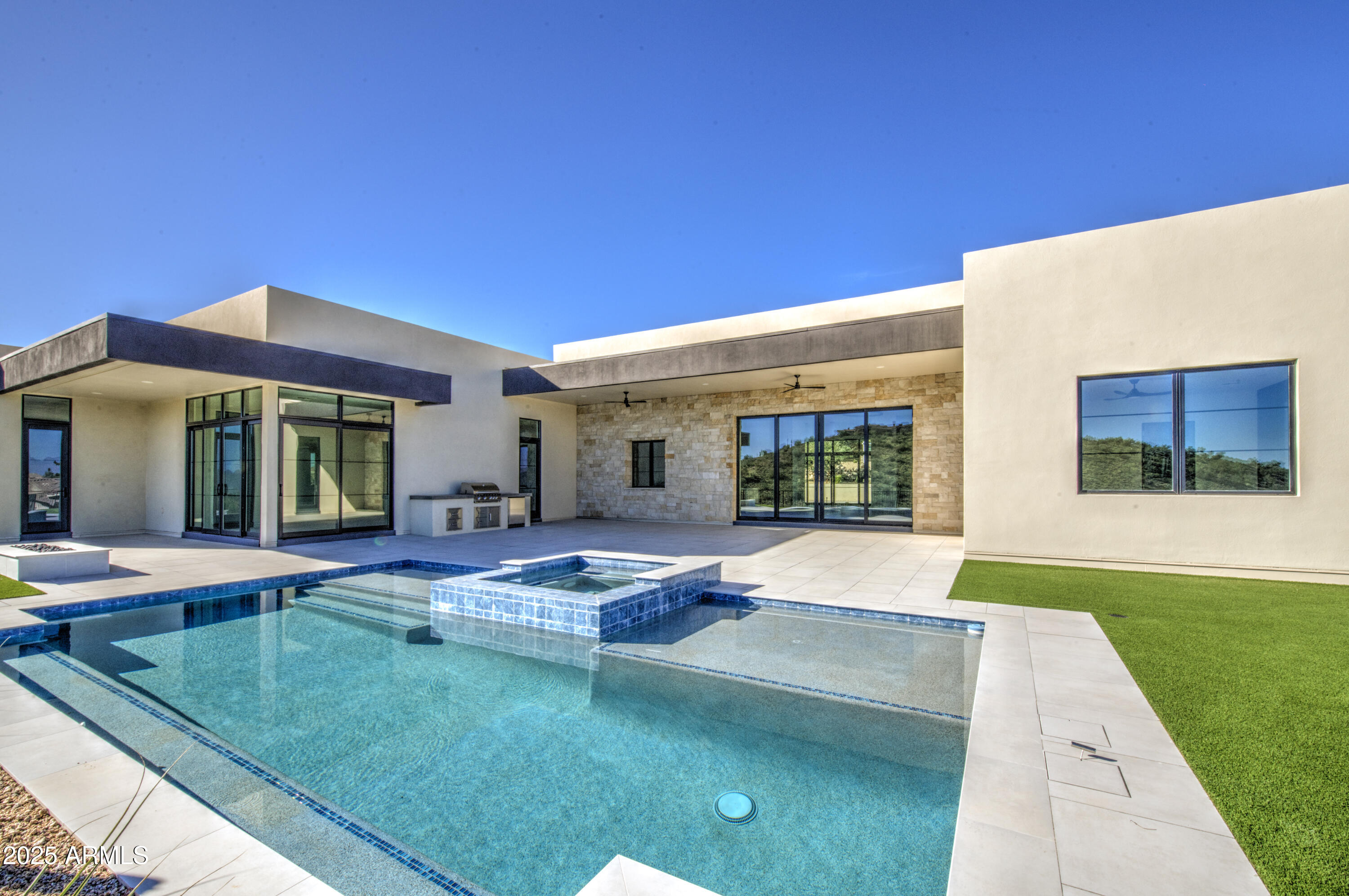 You are about to fall in love with this stunning custom property located in the amazing gated subdivision of Palatial Estates in Fountain Hills.  Located on a hill with beautiful views the home has contemporary touches everywhere you look. Step inside to an elegant entryway. There is wall to wall wood flooring and Cathedral-like high ceilings in the great room area.  Enormous kitchen and a kitchen that has it all including butler's pantry, wall ovens, contemporary light fixtures, granite countertops, and beautiful upgraded cabinetry with all the storage space you could dream of. Split floor plan with the primary bed on one side of the home and 3 large secondary bedrooms on the other. Formal dining room with  wine closet. Separate living & family rooms. You'll spend a lot of time entertaining and relaxing in the backyard that has covered patio, sparkling swimming pool, in-ground spa, built in BBQ, no-maintenance landscaping, and views to take your breath away.  Come see this beauty for yourself. You won't be disappointed.