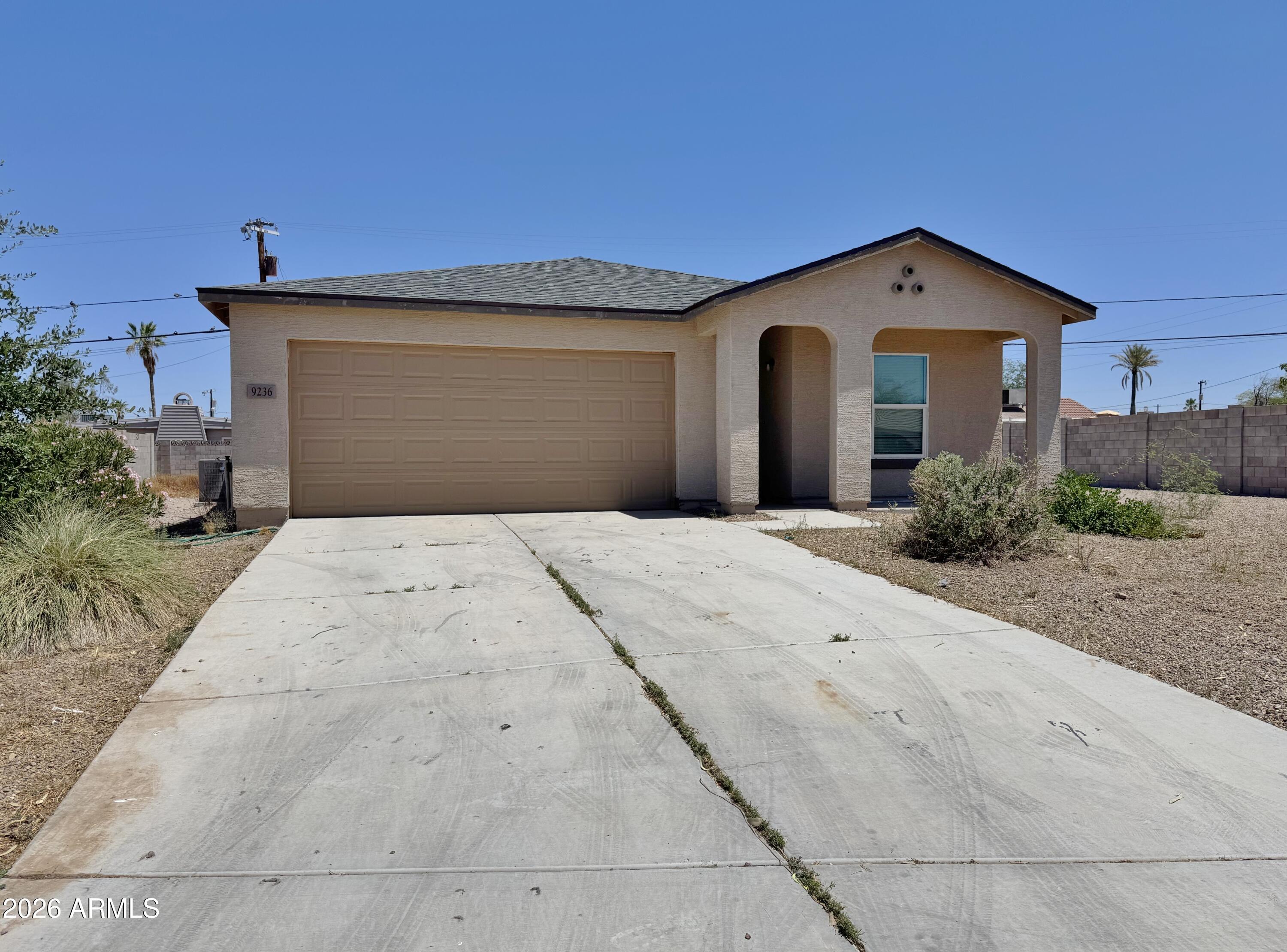 ALL SPIC AND SPAN AND READY FOR YOU!! Open floorplan with 3 bedrooms, 2 full baths and much more.  Spacious living area adjoins the dining and kitchen that has a huge pantry, stainless steel refrigerator plus built in microwave and ceramic top stove. Enjoy the upgraded granite counter tops in the kitchen and baths plus overhead lighting throughout. Master bedroom is set off from the other two and has a full length master closet plus the adjoining master bath has a double vanity plus tub/shower combination.  Spacious hallway has the laundry area, complete with washer and dryer plus a coat/storage closet. Home is set on a large lot with block fencing on both sides plus north south exposure and 2 car garage with opener. Situated just off the golf course in fast growing Arizona City. NO HOA!!