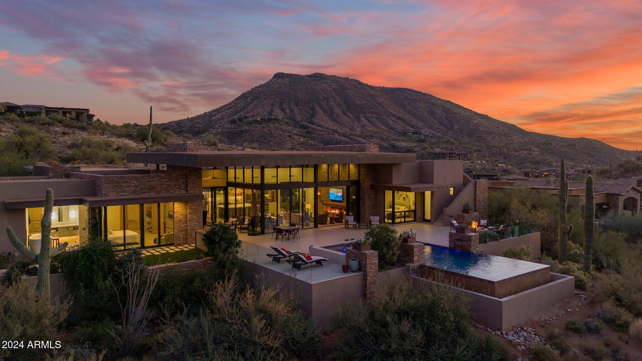 GOLF MEMBERSHIP AVAILABLE! This modern southwest contemporary by Salero Homes sits on a breathtaking view lot with unobstructed mountain and sunset views. Enjoy Sonoran Desert tranquility from every room through floor to ceiling glass and massive panel doors that bring the desert vistas indoors.  With 4600sq.ft. livable, this split floor plan offers a perfect balance of flowing living spaces, en-suite rooms, bonus areas, and a separate full guest casita. Rift cut custom oak cabinets, rift oak interior doors, beautiful quartzite slabs, Western panel doors and T&G wood ceilings are just a few of the surfaces you'll notice throughout this exceptional home. Enjoy endless patio spaces while Sunsets and Cactus backdrop the negative edge pool.  This home truly exudes the DM luxury lifestyle