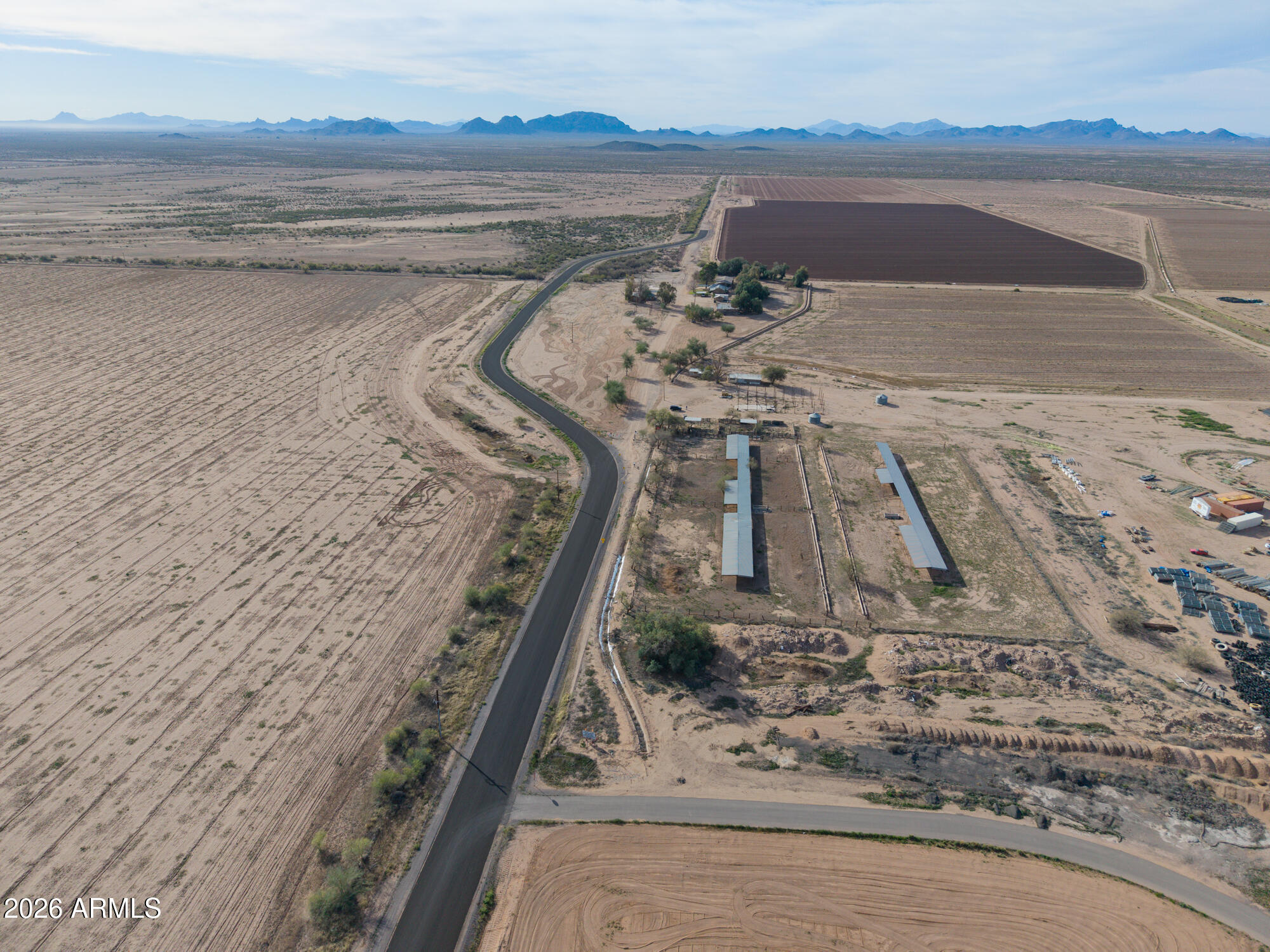 Extremely unique 16 acre parcel of land  abutting ''The Podium Club at Attessa'', a master planned racing community. The property features 16 acres of irrigated property with  3 houses, work shop and additional outbuildings. Also covered animal pens offering many opportunities. The property is located about 1 mile south of the I-8 interchange with close proximity to I-10 . Proposed  Interstate  I-11  runs along I-8 at Bianco Road. Seller is motivated to sell.