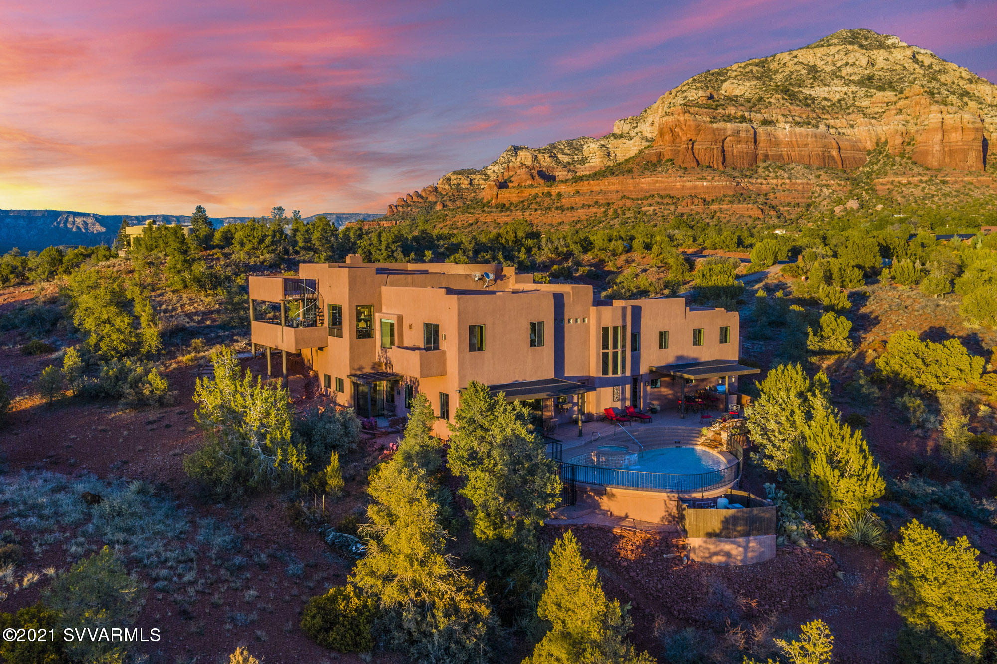 Located in the highly sought after, gated community of North Slopes, this custom home embodies Sedona living at its finest. Perfectly positioned on a large 2.04ac lot, this home captures the majestic sweeping red rock views surrounding the property. The property offers 370ft of direct forest service access allowing complete privacy to live your best life in serene tranquility and beauty. As you arrive at the home you will be greeted by a large 3 car garage and a beautiful courtyard with a kiva fireplace. Entering the home, you will find that it has been meticulously maintained and the warmth of natural sunlight will make you feel right at home. The kitchen features beautiful Viking appliances and granite countertops. The main living room is surrounded by panoramic views of Thunder Mountain
Chimney Rock, Cockscomb, and Doe Mountain. Imagine relaxing by the fireplace with your favorite book sitting in the mecca of some of Sedona's greatest attractions! The floor plan offers 6,267sqft of living space, 5 bedrooms, 5 bathrooms, an executive office, laundry room, game room with wet bar and fireplace, and to top it off a movie theater that seats 11. The master suite offers a walkout deck, large walk-in closet, and spacious en-suite with postcard views from the jacuzzi tub. The home offers 5 separate viewing decks and the main deck located off the living room features a built-in BBQ. The backyard offers a true resort feel with a swimming pool, jacuzzi, built-in BBQ, and fire pit. Interested in hiking? This home is surrounded by trails and offers private access to adventure! This home needs to be seen to genuinely appreciate the beauty and magnificence of the location and build. Schedule your showing today!