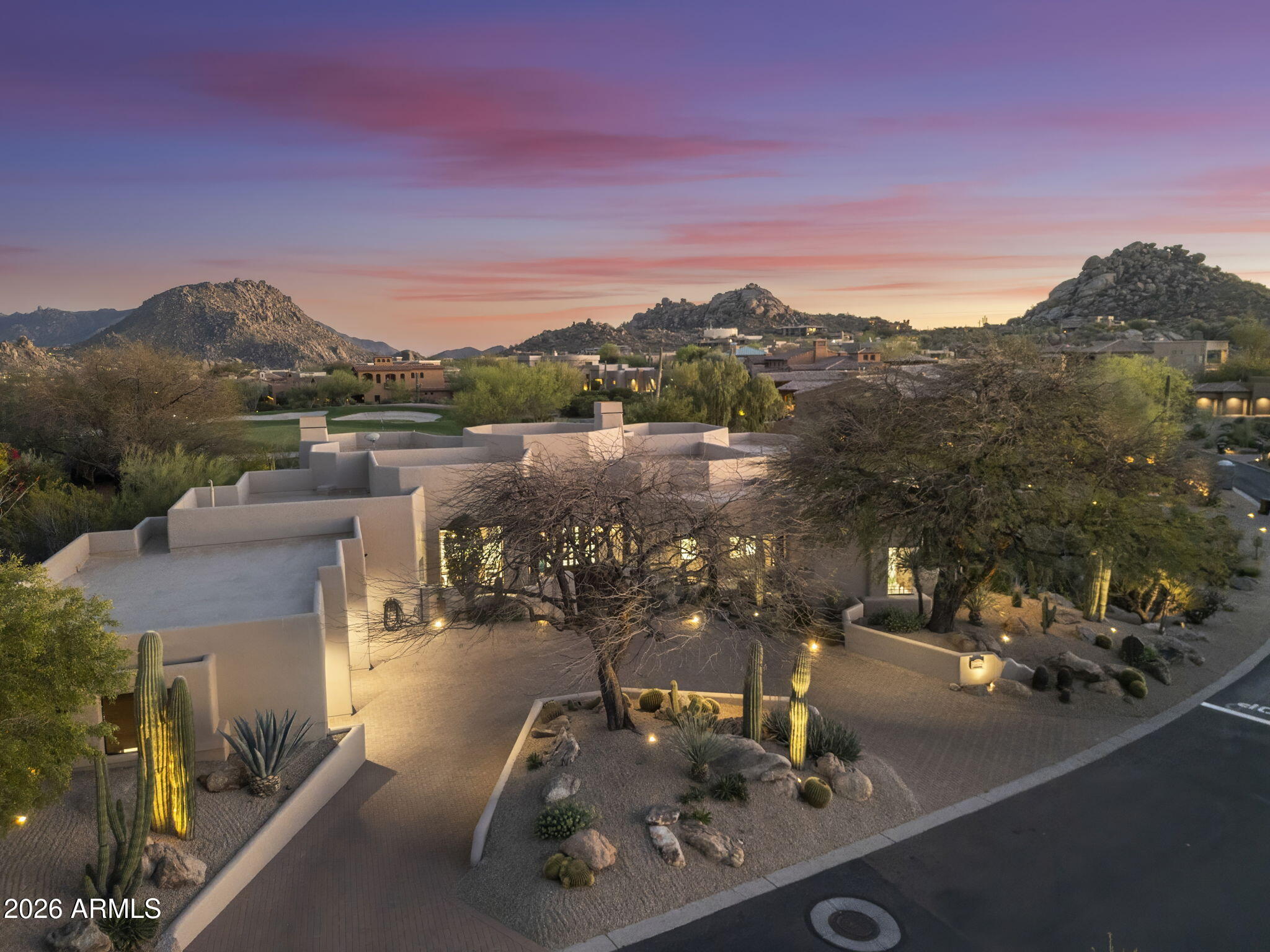Completely reimagined in 2025, this luxury residence in gated Pinnacle Canyon at Troon North sits on a premier golf course and mountain view lot across from Troon North Golf Club, surrounded by the McDowell Mountains. Walls removed create expansive, light-filled living with hewn wood beam ceilings, multiple fireplaces & seamless indoor-outdoor flow. Curated finishes include handcrafted cabinetry, quartzite surfaces, stunning flooring & designer fixtures. Split floorplan encapsules Primary Retreat Wing; Junior Primary Casita & Jr. Primary Wing near side entry + office/den & Spa pool. Chef's kitchen, outdoor kitchen & entertainment and view patios capture breathtaking sunrise, sunset & golf views. Moments from world class golf, dining, shopping, hiking, boating and more. Call today. MORE... Gated 2025 mountainview renovation: Transformation of 3BR/3.5BA/Casita/+Den/Mountain & Golf Course VIEWS! Newly designed masterpiece w/ Guest Casita! Every detail reflects refined craftsmanship--from exposed wood beams to bespoke handcrafted cabinetry, to curated stone framing the fireplaces, making an exceptional statement, from floor to ceilings. The dining area garners the cascading mountain view with sunsets to embellish every great meal there...and flowing effortlessly into new chef's kitchen of exceptional design, featuring premium appliances, pristine surfaces, and an oversized quartzite island, with a sunlit breakfast nook perfectly positioned for morning light and dazzling views of both mountains and golf course greenery.

The primary suite is a private retreat, offering a generous layout, sitting area, patio access, and a spa-inspired bath with a jetted luxury soaking tub, circular stone rain shower, dual vanities, and room-sized dual walk-in closets. Additional bedrooms are on separate guest wings as well as outdoors to Casita. Guest bedrooms offer spacious, well-appointed privacy. The detached casita with private entry provides ideal flexibility for guests or multigenerational living. Guests love their separate view patio landscaped with seating.

Outdoor living is equally compelling, with additional covered patios, fireplace patio for dining and lounging, and the crown jewel of the yard -- a resort-style pool, jetted waterfall spa, manicured grounds, and two fully equipped outdoor kitchens. Multiple seating areas create an inviting setting for evenings under Arizona's desert skies.

Set against the dramatic backdrop of North Scottsdale, Pinnacle Peak, Troon and McDowell Mountains, this just-delivered Mark Lane renovation embodies elevated Sonoran living--seamlessly blending indoor-outdoor design, curated finishes, and sweeping desert and mountain views. Designed for both intimate living and effortless entertaining, it offers a rare balance of privacy, beauty, and timeless architecture.

Noteworthy amenities include: Four Seasons at Troon North social membership, Troon North Golf Club, Troon Country Club, Pinnacle Peak Trailhead, private pickleball courts, The Boulders, nearby dining and shopping, Lake Bartlett, and access to the Tonto National Forest.

Call today to schedule your private tour.
